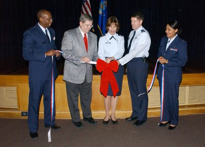 Capt. Radcliff Myers, Kenneth Williams, 59th Medical Support Group Commander Col. Kimberly Slawinski, 37th Training Wing Vice-commander Col. Eric Wilbur and Maj. Claudine Wega cut the ribbon Feb. 2 to officially commence the base's recognition of African-American History Month. The opening ceremony was conducted in the Wilford Hall Medical Center auditorium on Lackland Air Force Base, Texas. Chief Master Sgt. Candance Curtz, WHMC's manager of cardiopulmonary services, was the guest speaker. Other speakers included Maj. Claudine Wega, who spoke about Frederick Douglas, and 2nd Lt. David Herndon, who spoke about Hiram Rhodes Revels. (USAF photo by Alan Boedeker)                                          