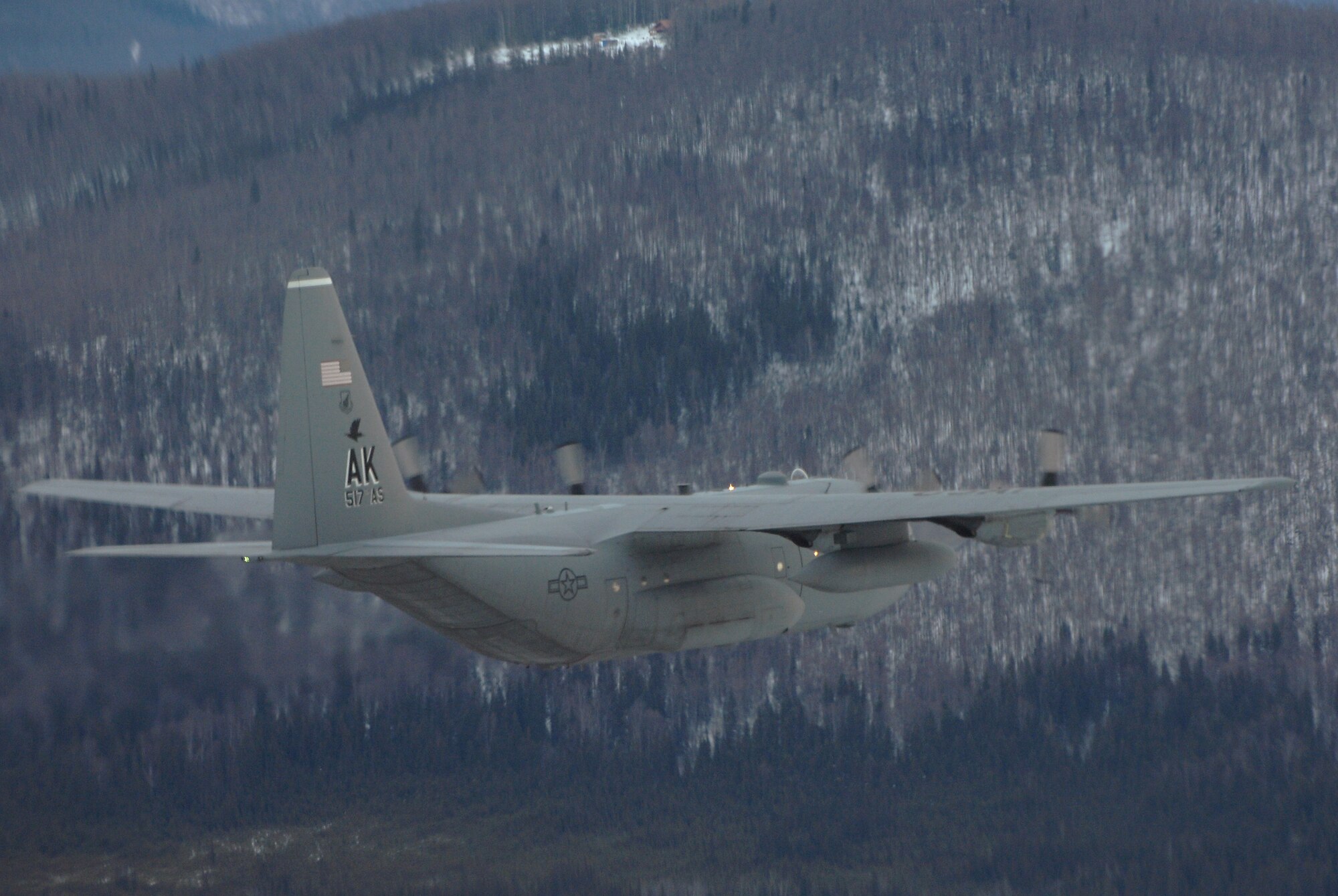 ELMENDORF AIR FORCE BASE, Alaska -- A C-130 flys a training mission in the Alaskan Interior. The C-130 belongs to the 517th Airlift Squadron. The 517th AS will replace its fleet of C-130s with the C-17 Globemaster III later this year. (Photo by Tech. Sgt. Keith Brown)