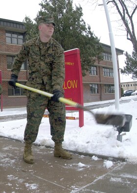 Marine Pfc. Donald Wolcott, a tech school student, shovels snow from the sidewalk leading to the Marine Corps Detachment Wednesday.  Goodfellow experienced its first snow fall of the year Tuesday.  Base personnel were released early from duty Tuesday afternoon and were ordered to report to work by no later than 9:30 a.m. Wednesday.  Personnel were once again released from duty by 2 p.m. Wednesday.  The early releases were done as a preventative measure by the senior leadership because of the hazardous driving conditions caused by the snow storm and cold weather conditions of the week.  Several areas of Goodfellow received two to three inches of snow. (U.S. Air Force photo by Airman 1st Class Luis Loza Gutierrez)