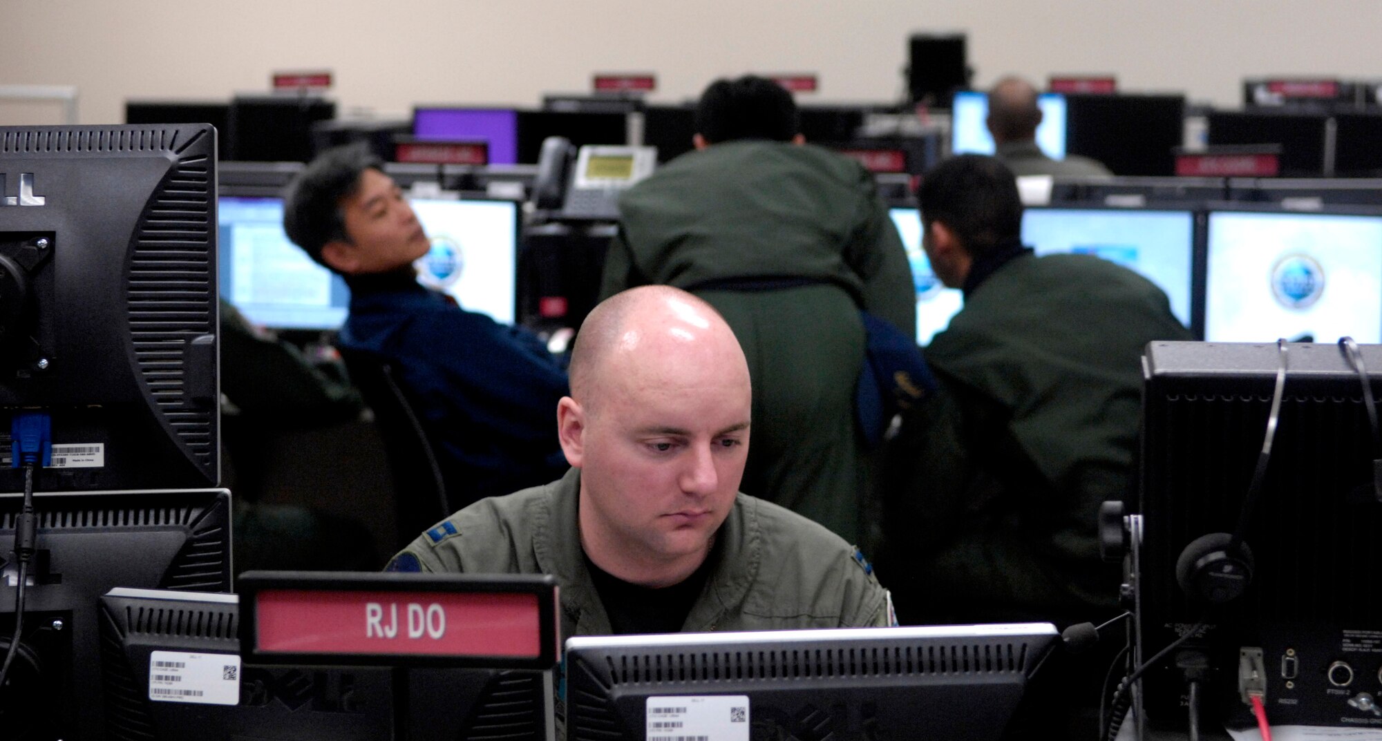 Capt. David Rogers coordinates air packages for time sensitive targets during Exercise Keen Edge '07 Feb. 2 at Hickam Air Force Base, Hawaii. Captain Rogers is assigned to the 50th Flying Training Squadron at Columbus AFB, Miss., and is an augmentee to the 613th Air Operation Center. Keen Edge is joint bilateral exercise to increase combat readiness and interoperability with the Japan Air Self Defense Force. (U.S. Air Force photo/Tech. Sgt. Shane A. Cuomo) 