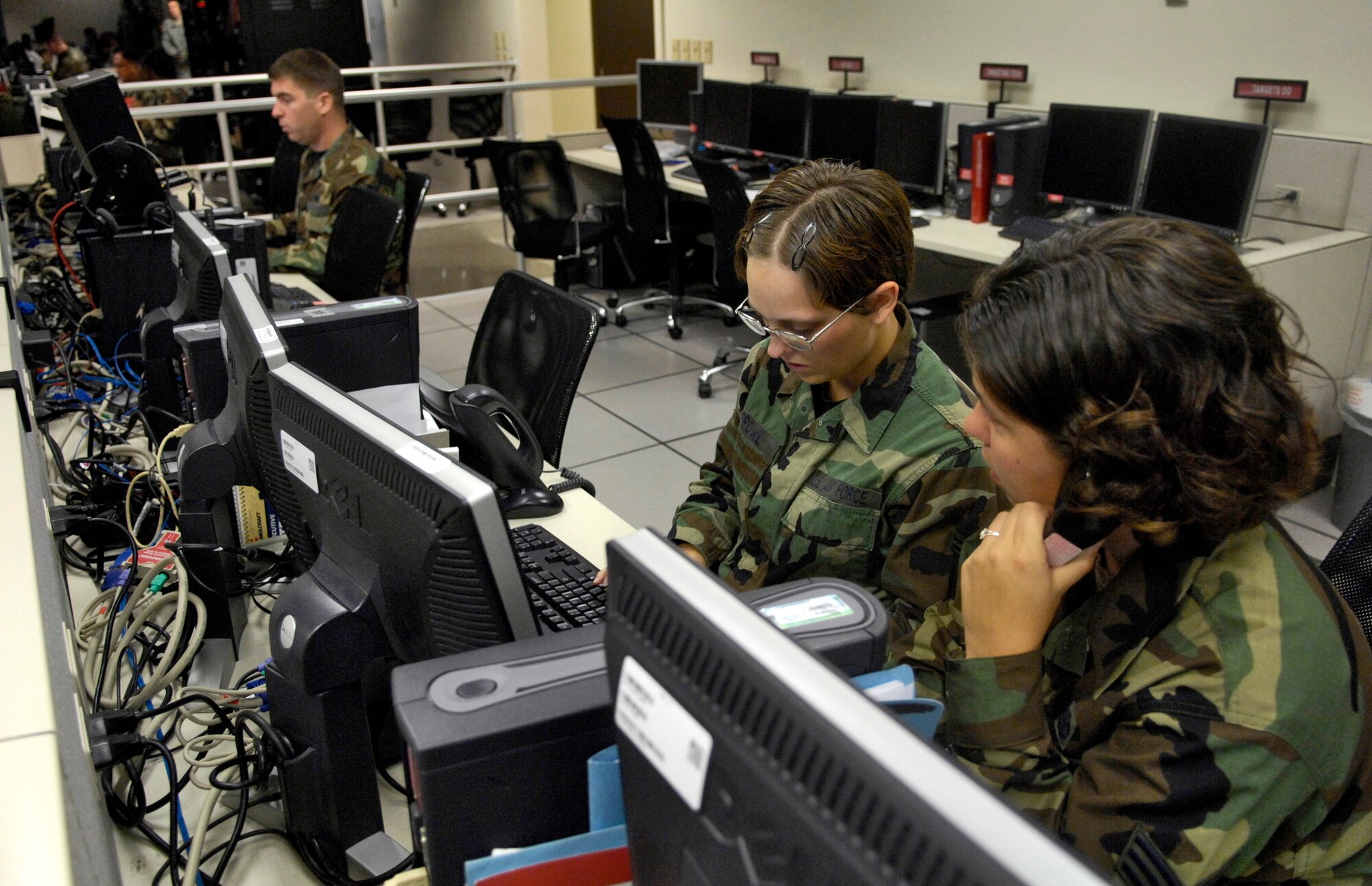 Airman 1st Class Whitney Sprowl and Senior Airman Samatha Blaine provide bilateral coordination for command and control of intelligence, surveillance and reconnaissance operations during Exercise Keen Edge '07 Feb. 2 at Hickam Air Force Base, Hawaii. The Airmen are from the 613th Air Operations Center. Keen Edge is a joint bilateral exercise to increase combat readiness and interoperability with the Japan Air Self Defense Force. (U.S. Air Force photo/Tech. Sgt. Shane A. Cuomo) 

