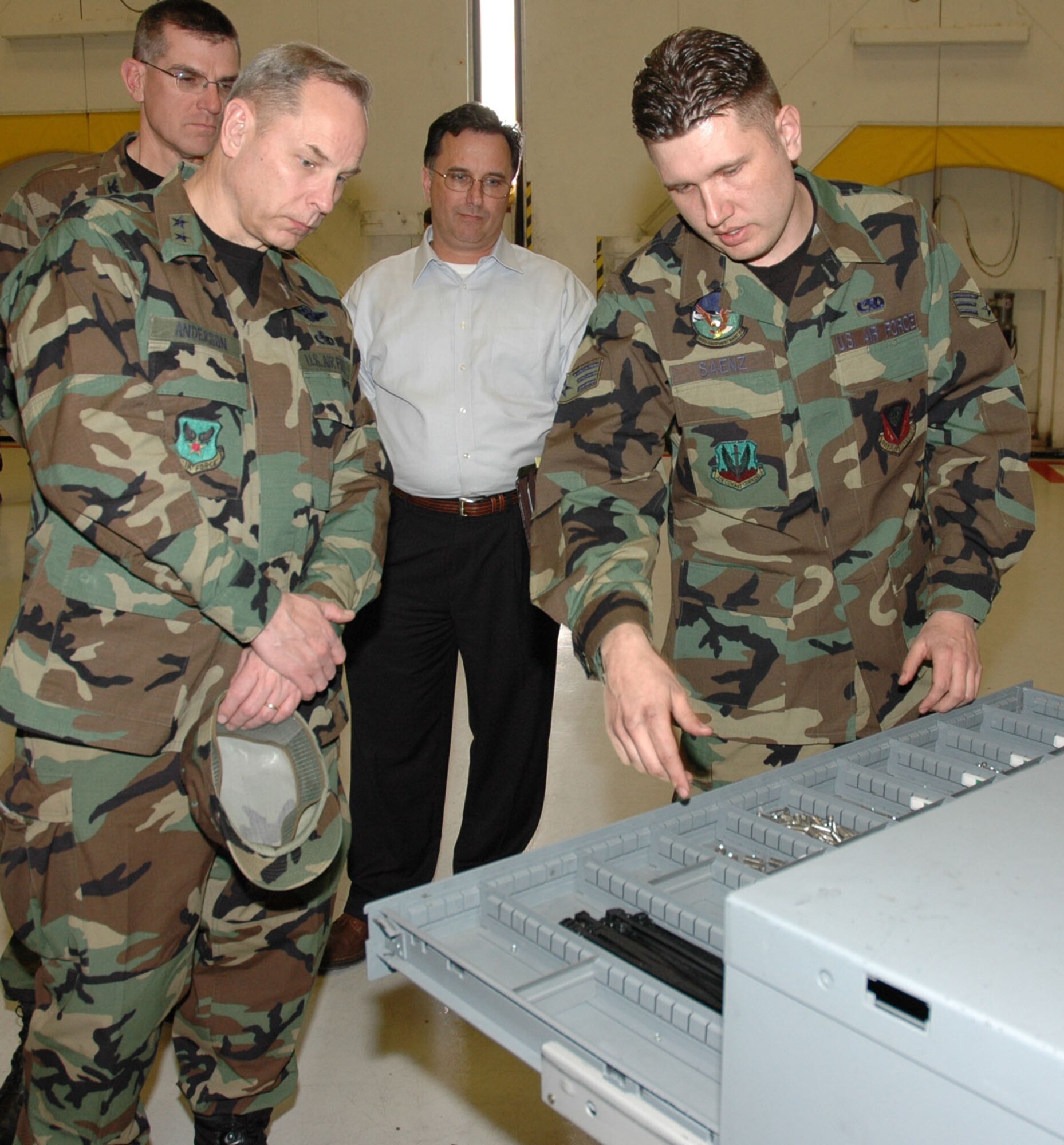 MOUNTAIN HOME AIR FORCE BASE, Idaho – Senior Airman Edward Saenz from the 366th Equipment Maintenance Squadron phase dock briefs (from left) Maj. Gen. Mark Anderson, Col. Jay Santee and Walter Poliansky on the time-saving initiatives the squadron uses during its regularly scheduled “phase” inspections on the wing’s fleet of F-15 fighters. General Anderson, mobilization assistant to the Air Force deputy chief of staff for installations and logistics at the Pentagon, Colonel Santee, 21st Space Wing commander at Peterson Air Force Base, Col., and Mr. Poliansky with the Air Force readiness and installation support division at the Pentagon, led a team of inspectors visiting the base Feb. 4 to 6 as part of the 2007 Commander in Chief’s Annual Award for Installation Excellence. Mountain Home is one of three Air Force bases currently vying for the annual honor, which recognizes outstanding and innovative efforts of people at military installations like Mountain Home. Airman Saenz showed the team how locally established procedures cut more than 1 1/2 days off his shop’s in-depth aircraft inspections. Air Force photo by Master Sgt. Brian S. Orban