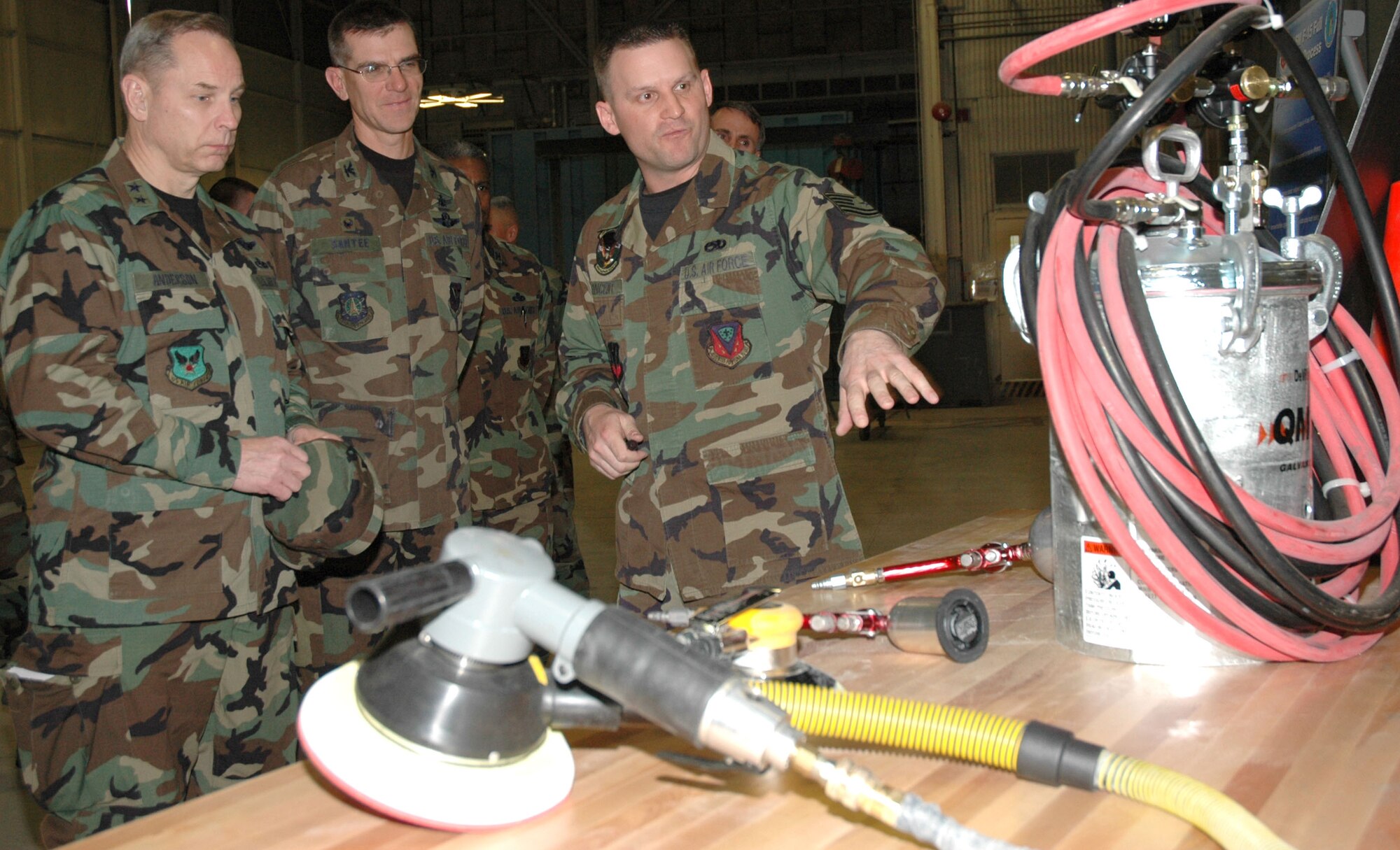 MOUNTAIN HOME AIR FORCE BASE, Idaho – Tech. Sgt. Mike Vincent, an aircraft structural craftsman with the 366th Equipment Maintenance Squadron paint barn here, highlights some of the advanced equipment his shop uses to repaint the wing’s fleet of aircraft to Maj. Gen. Mark Anderson and Col. Jay Santee during a visit here Feb. 5. General Anderson, mobilization assistant to the Air Force deputy chief of staff for installations and logistics at the Pentagon, and Colonel Santee, 21st Space Wing commander at Peterson Air Force Base, Col., led a team of inspectors visiting the base Feb. 4 to 6 as part of the 2007 Commander in Chief’s Annual Award for Installation Excellence. Mountain Home is one of three Air Force bases currently vying for the annual honor, which recognizes outstanding and innovative efforts of people at military installations like Mountain Home. Sergeant Vincent briefed the team on their refined procedures, which cut two days off the time it takes to repaint a jet during regularly rescheduled corrosion control. Air Force photo by Master Sgt. Brian S. Orban