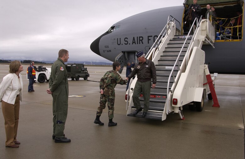 Col. Teresa Djuric, 30th Space Wing vice commander, Col. Robert Gibson, 381st Training Group commander, and Linda Gates, an Air Education Training Command community leader, greet Gen. William R. Looney III, AETC commander, as he steps out of a KC-135.  General Looney escorted a group of community leaders from around the country to the 381st Training Group to show how space and missile operators and maintainers are trained.  (U.S. Air Force photo by Maj. Carol McClelland)