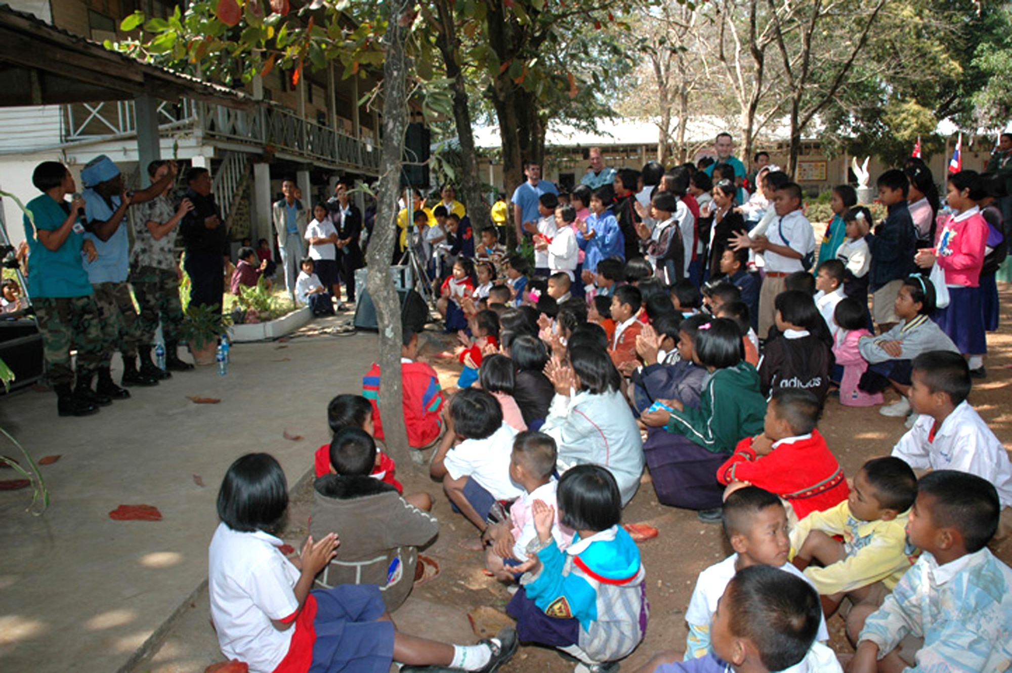 The U.S. dental staff takes time out of the day to entertain students of the Ban Chaimongkon school Jan. 30 in Korat, Thailand. Medical members from the United States, Thailand and Singapore air forces performed medical, dental and eye exams for members of the school community. Military members from the three countries took part in a humanitarian mission at the school as part of Exercise Cope Tiger 2007. (U.S. Air Force photo/Staff Sgt. Betty Squatrito-Martin) 