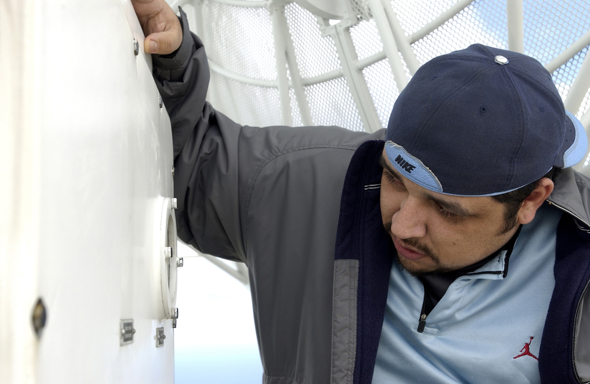 Salvador Sanchez, contractor for Western Range Operations Communications and Information (WROCI), checks the oil of the FPS-16 radar.  The radar is used to track Vandenberg launches from atop Tranquillon Peak on Vandenberg AFB.  The oil inside the radar is used for mobility purposes so it is able to move 360 degrees without getting stuck, thus able to track the upcoming Minuteman III missile launch on Feb. 7.  (U.S. Air Force photo by Airman 1st Class Ashley Tyler)