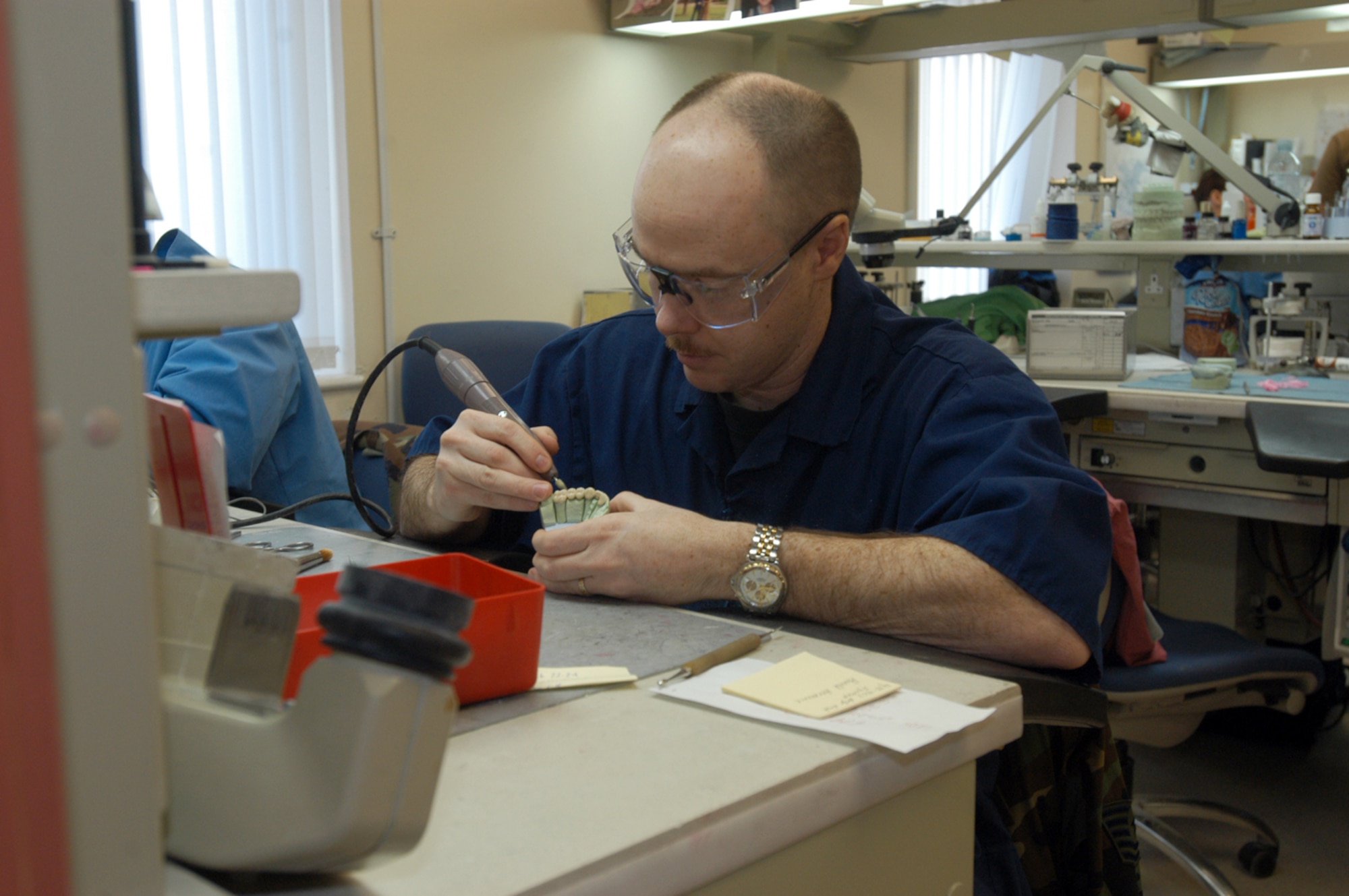Tech. Sgt. Lloyd Cross, 48th Dental Squadron laboratory technician, puts the final touches on a dental implant. The dental lab works on everything from crowns
to porcelain implants used to cover or replace teeth when they need to be strengthened, rebuilt or replaced.