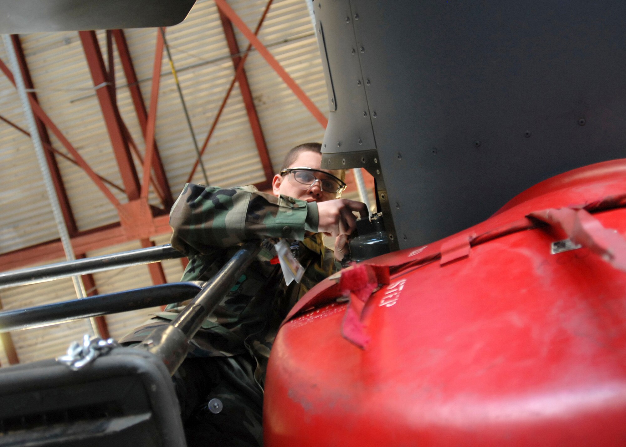 KIRTLAND AIR FORCE BASE, N.M. -- Airman Emanuel Borcean, a CV-22 maintenance apprentice, takes grease samples from the swashplate of a CV-22. Through the hard work of maintainers and operators, the CV-22 achieved a milestone Jan. 30 when the 58th Special Operations Wing, here, announced that it was ready to train aircrews for the Air Force Special Operations Command. (U.S. Air Force photo by Laurence Zankowski)