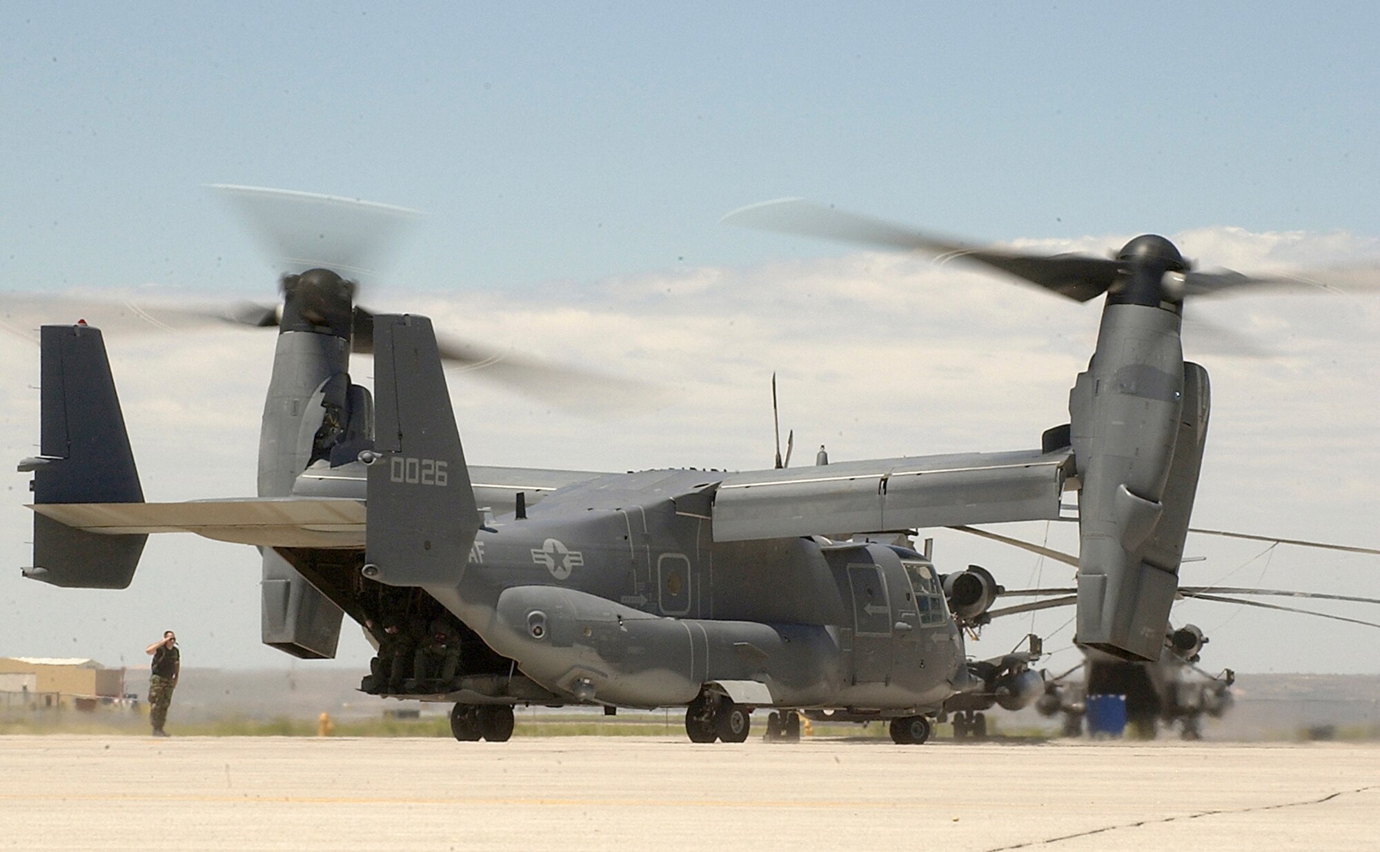 KIRTLAND AIR FORCE BASE, N.M. -- An Airman salutes the pilot of a CV-22 Osprey here before its departure from the runway here. The CV-22 program has reached another milestone as the 58th Special Operations Wing, here, announced Jan. 30 that they have the aircraft, maintenance infrastructure and training cadre ready to begin training aircrews for the aircraft. (U.S. Air Force photo by Staff Sgt. Markus M. Maier)                               