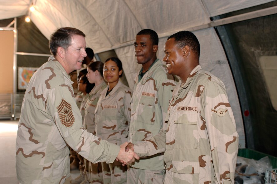 Chief Master Sergeant of the Air Force Rodney J. McKinley shakes hands with Airman Damian Dawkins Feb. 5 in Southwest Asia. Chief McKinley spoke to Airmen about changes in the Air Force that will be implemented in upcoming months. Airman Dawkins is a 379th Expeditionary Logistics Readiness Squadron mobility technician. (U.S. Air Force photo/Staff Sgt. David Miller)