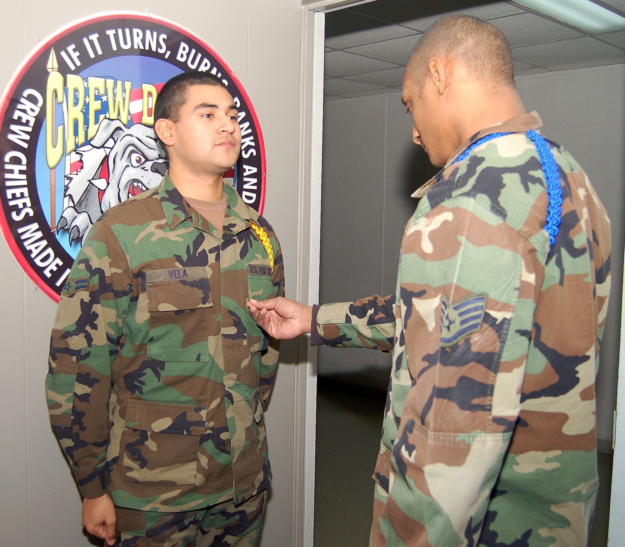 DOVER AIR FORCE BASE, Del.  Staff Sgt. Robert Jackson, 373rd Training Squadron MTL, inspects Airman 1st Class Carlos Vela, 373rd TRS student and student leader. Student leaders wear colored ropes to designate their position and play a large role in the developement of other students. (U.S. Air Force photo/Tech. Sgt. Kevin Wallace)