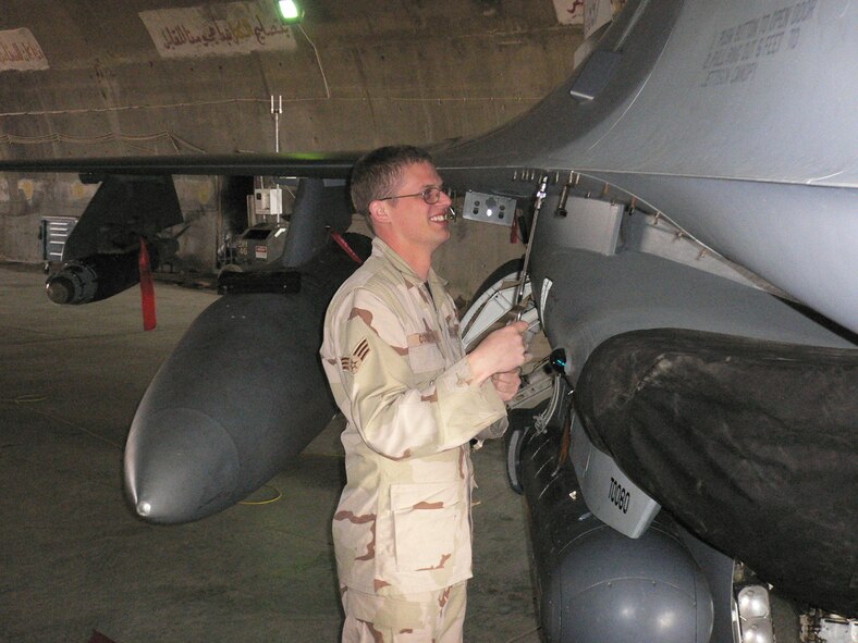 02/02/2007 -- BALAD AIR BASE, Iraq -- Staff Sgt. Robert Compton, 332nd Expeditionary Aircraft Maintenance Squadron, performs preventive maintenance on a F-16 jet here. Sergeant Compton who was recently promoted is deployed from the 35th Aircraft Maintenance Squadron at Misawa Air Base, Japan. (U.S. Air Force photo by Capt. Jeffrey Campbell)