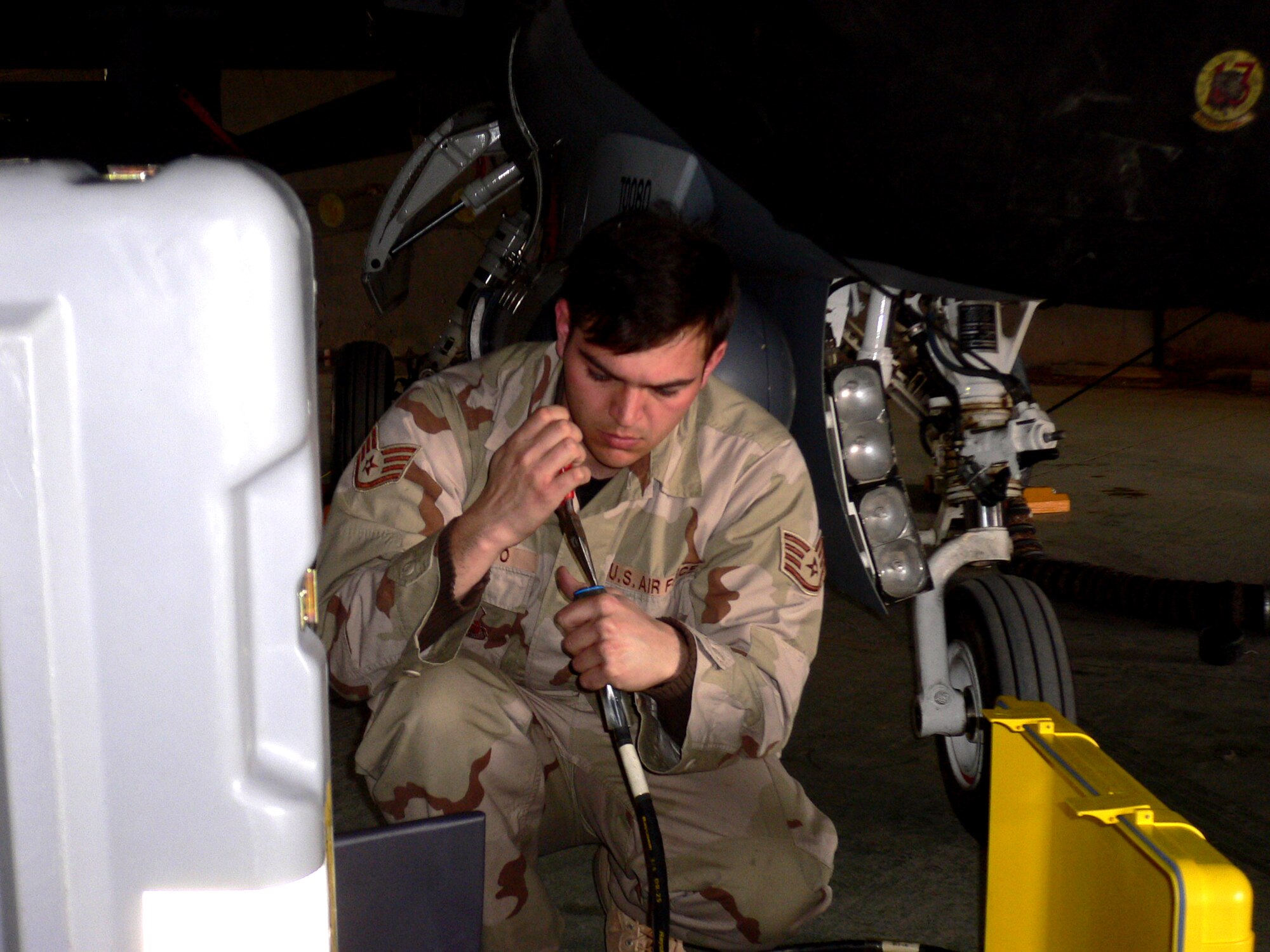 02/02/2007 -- BALAD AIR BASE, Iraq -- Staff Sgt. James Dinardo, 332nd Expeditionary Aircraft Maintenance Squadron, performs preventive maintenance on a jet here. Sergeant Dinardo is deployed from the 35th Aircraft Maintenance Squadron at Misawa Air Base, Japan. (U.S. Air Force photo by Capt. Jeffrey Campbell)