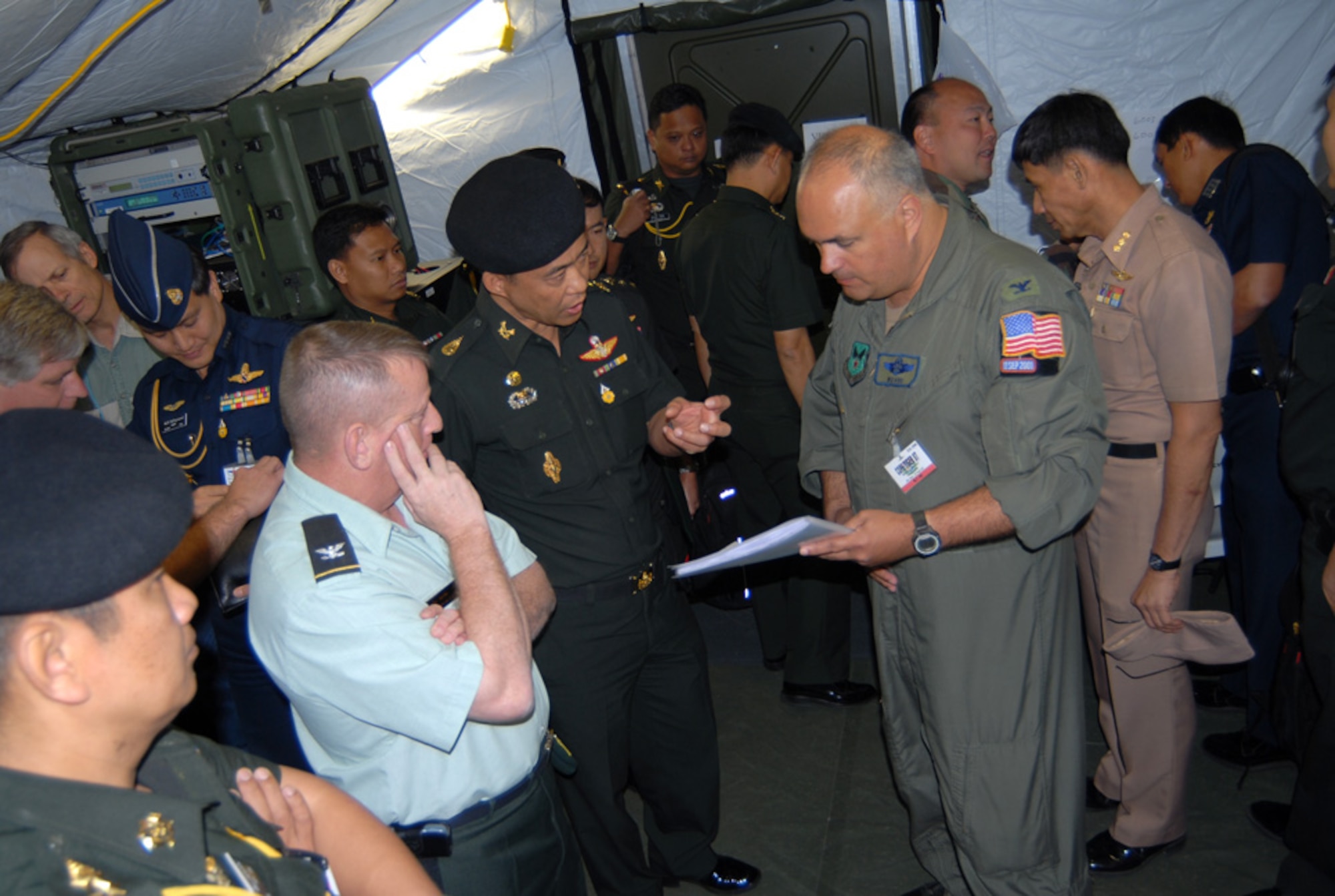 Col. Kevin Clark (L), Commander Joint U.S. Military Advisory Group, Thailand; and Col. J.R. Sotomayor (R), Director of Operations CSAF Innovation Programs, listen as Lt. Gen. Worapong Sanganet, J-3 Director of Joint Operations, of the Royal Thai Air Force, asks questions about the capabilities of Eagle Vision equipment.  General Sanganet toured the Eagle Vision V compound during Exercise Cope Tiger 07 in Korat, Thailand.  Cope Tiger helps cultivate common bonds, build strong relationships and strengthen interoperability with nations in the region by training side-by-side with their military forces.  (USAF photo by Master Sgt. Kristen Higgins)