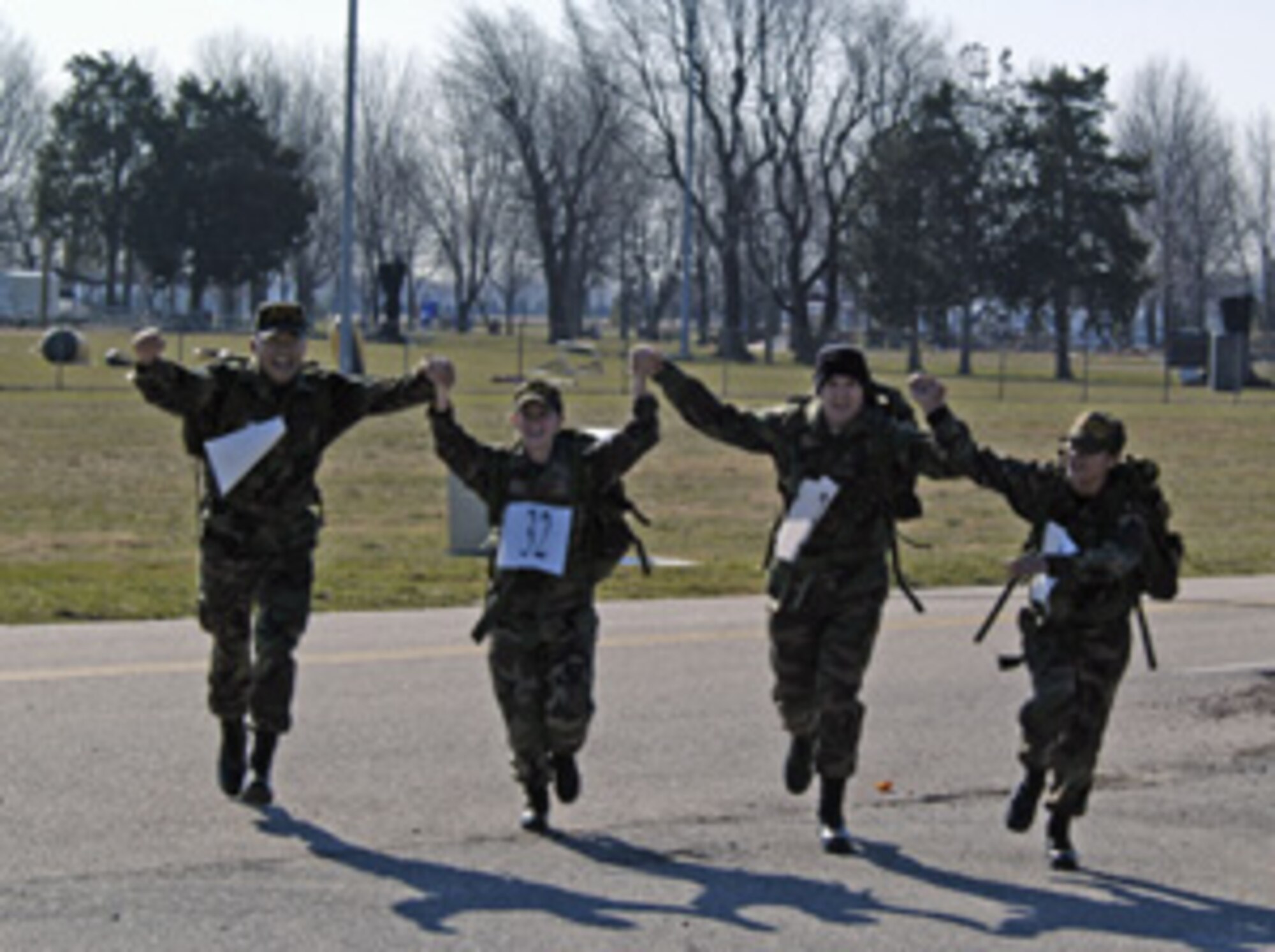 (Left to right) Master Sgt. Sam Louie, Airman 1st Class Angela Daugherty, Airman 1st Class John Thorman and Staff Sgt. Jessica Holcomb, 436th Aerial Port Squadron, cross the finish line during the 8th Annual 436th Security Forces Ruck March at the Air Mobility Command Museum Saturday. (U.S. Air Force photo/ Staff Sgt. James Wilkinson)
