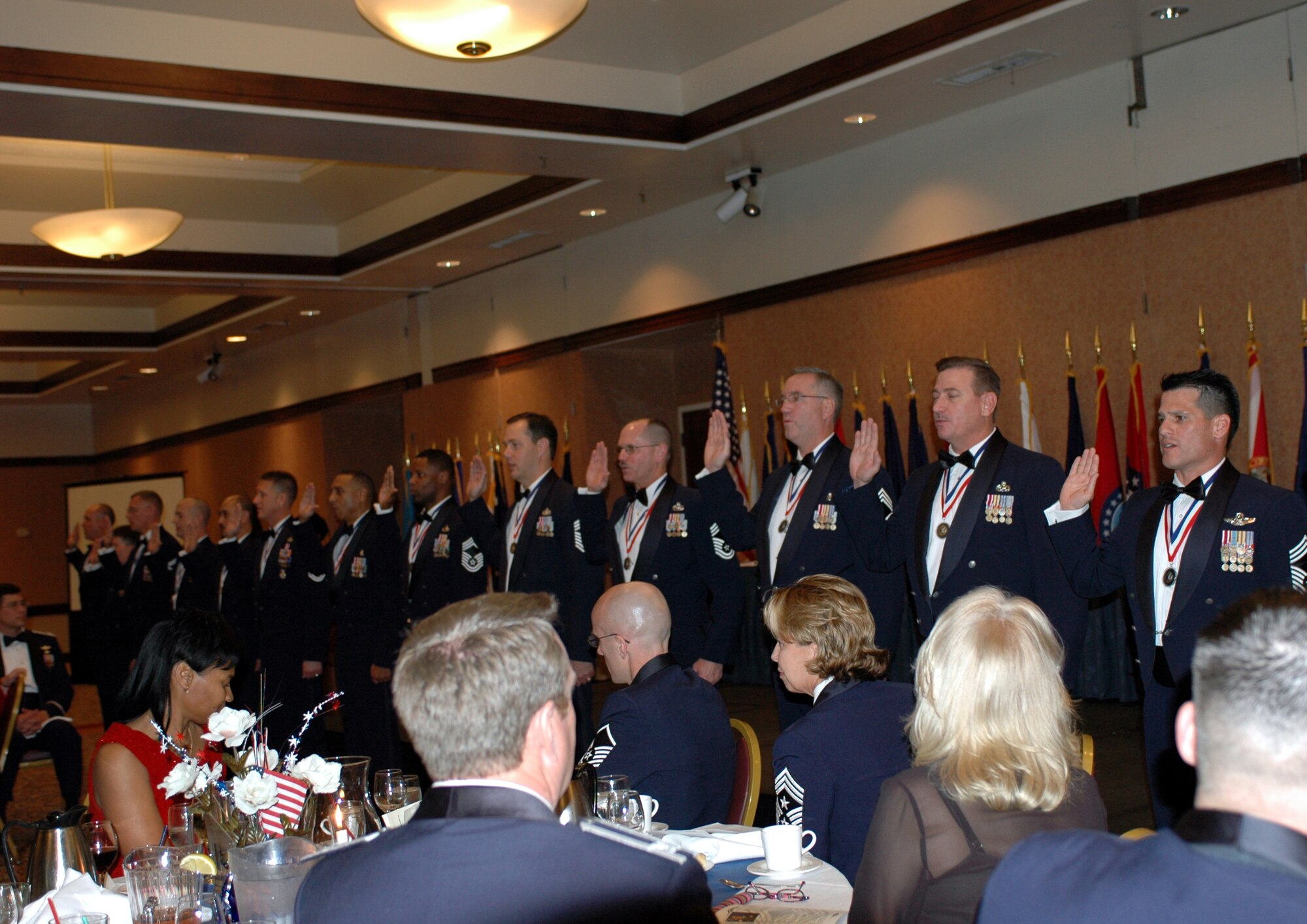 Team Travis’ new chiefs take the chiefs' oath during the Chief’s Induction ceremony Feb. 2. Team Travis honored 14 of their newest chief master sergeants during a formal recognition ceremony at the Delta Breeze Club. (U.S. Air Force photo by Staff Sgt. Candy Knight)