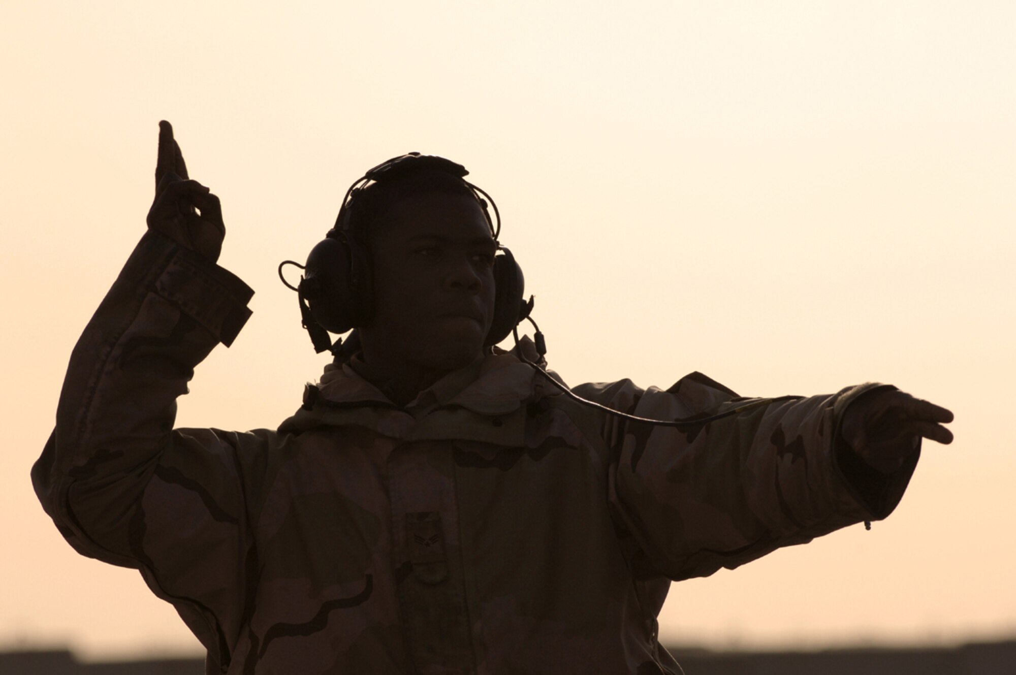 01/29/2007 -- BALAD AIR BASE, Iraq -- Senior Airman Robert Gattison, 14th Expeditionary Aircraft Maintenance Squadron, marshals Lt. Col. Chris "crash" Ashby, 332nd Air Expeditionary Wing, and his block 50 F-16 away from the hardened aircraft shelter toward the runway  for a combat mission from Balad Jan. 29. Airman Gattison is deployed from Misawa Air Base, Japan. Colonel Ashby is deployed from Shaw Air Force Base, S.C. (U. S. Air Force photo by Staff Sgt. Michael R. Holzworth) 

