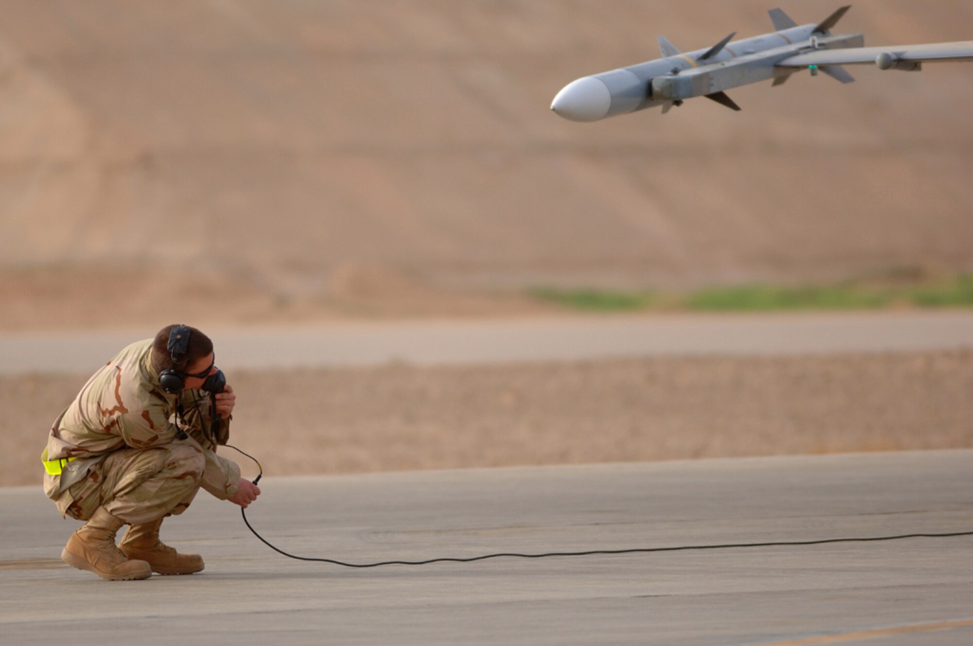 01-29-2007 -- BALAD AIR BASE, Iraq -- Senior Airman Skyler Mims, 14th Expeditionary Aircraft Maintenance Squadron, looks over the F-16 and while communicating with Capt. Wiilliam "shogun" Lutmer, 14th Expeditionary Fighter Squadron, to perform pre flight checks before launching his Block 50 F-16 on a combat mission from here Jan. 29. Airman Mims is deployed from Misawa Air Base, Japan. (U. S. Air Force photo by Staff Sgt. Michael R. Holzworth) 


