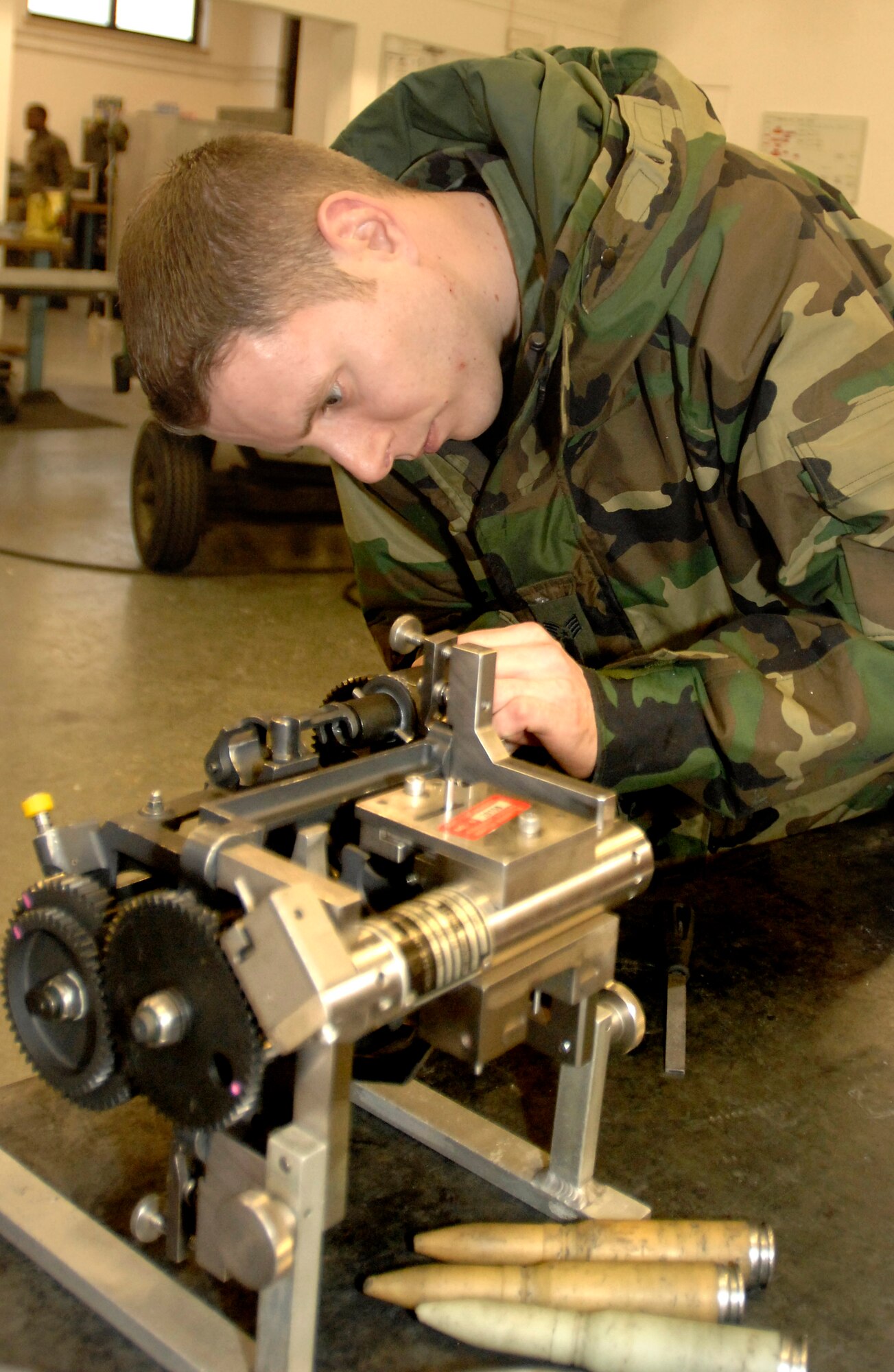 Staff Sgt Tony Simper inspects the drum exit unit of an F-16 Fighting Falcon gun system Feb. 6 at Aviano AB, Italy. Sergeant Simper is an aircraft armament system craftsman with the 31st Maintenance Squadron Armament Flight. The flight is responsible for the maintenance of F-16 weapons systems. (U.S. Air Force photo/Airman 1st Class Liliana Moreno) 
