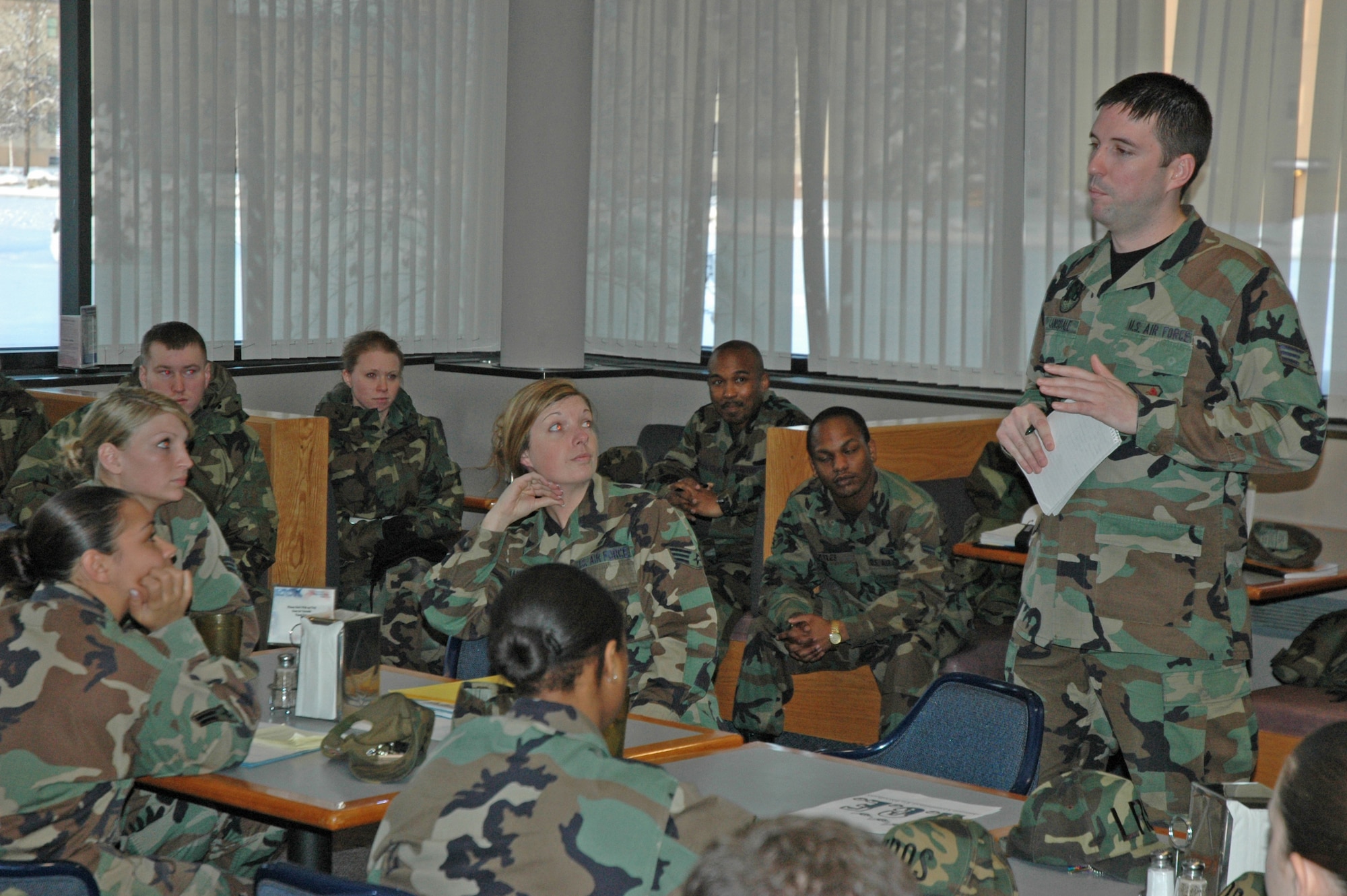 EIELSON AIR FORCE BASE, Alaska--Senior Airman Jonathan Cansdale, Airmen Committed to Excellence president, speaks to Airmen E-1s through E-4s about upcoming fundraisers, activities and volunteer work Feb. 1 at the dining facility. A.C.E. is a private, non-profit organization that voices the opinions of Airmen to the command chief to let him know what interests or concerns the lowest tier of Airmen have. (U.S. Air Force photo by Airman 1st Class Nora Anton)