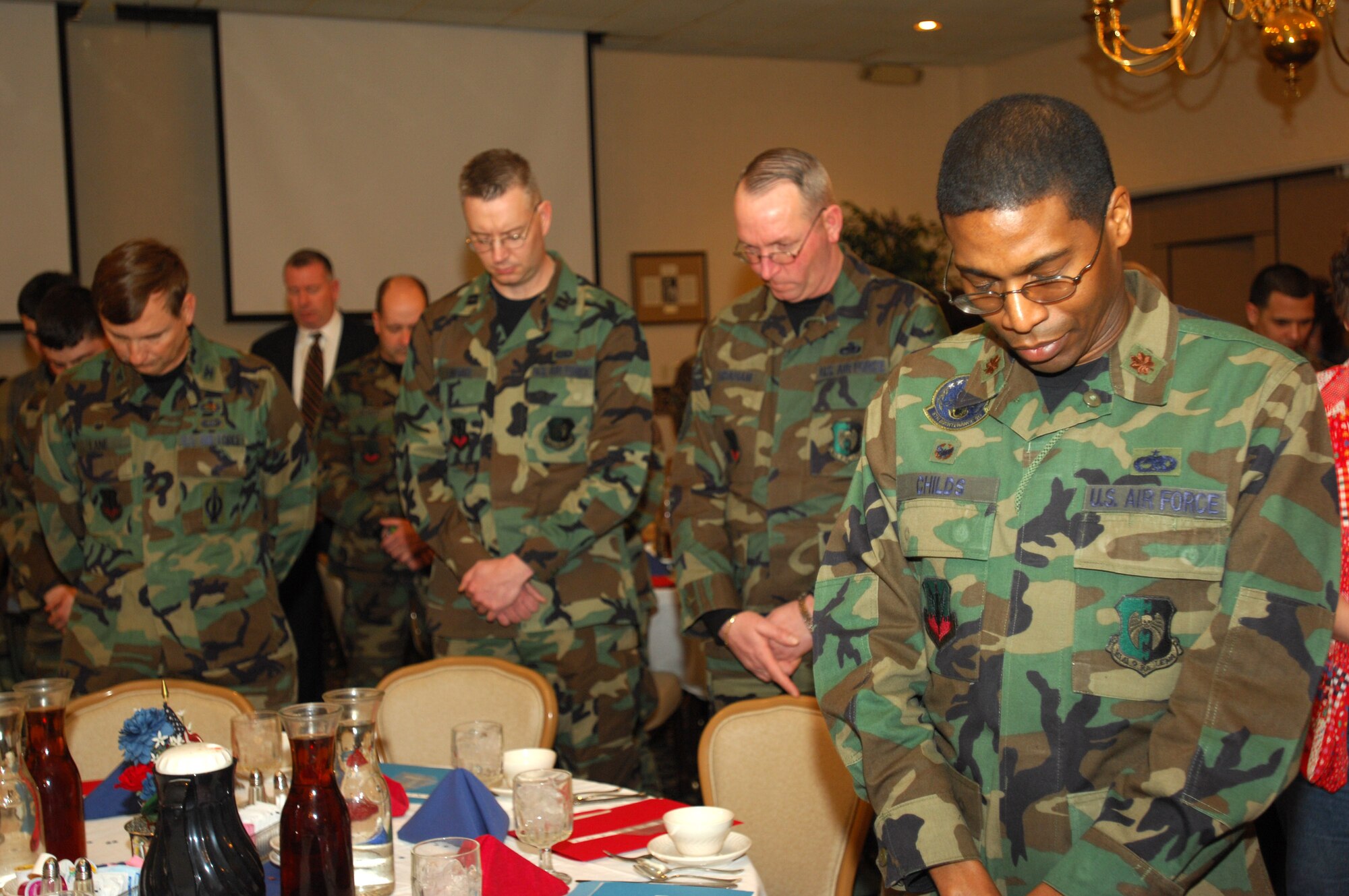 MINOT AIR FORCE BASE, N.D. -- Airmen bow their heads for a moment of silence during the base’s annual national prayer event at the Jimmy Doolittle Center here Feb. 2.  Hundreds of Team Minot members gathered to hear keynote speaker Chaplain (Maj. Gen.) Charles Baldwin, Air Force chief of chaplains. (U.S. Air Force photo by Airman 1st Class Sharida Bishop)