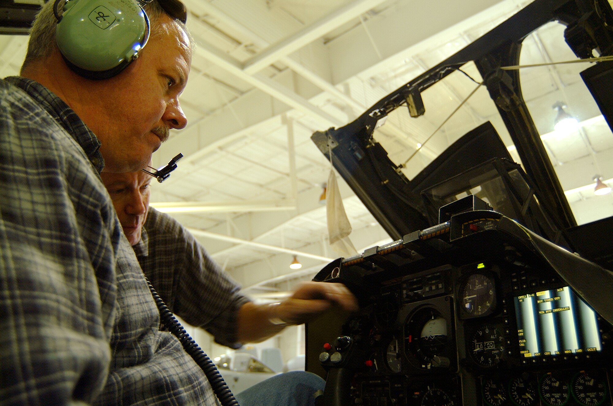 Tech. Sgts. and air reserve technicians Jim Wilson, left, and Paul Hanson, check a test pattern on a smart multi-function color display on the right side of the cockpit in A-10 number 605 in December.  Members of the 442nd Aircraft Maintenance Squadron's Specialist Flight must operationally check the system after installing the components.  (U.S. Air Force photo/Maj. David Kurle)