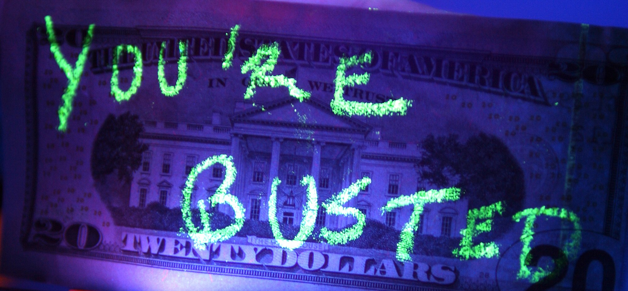 EIELSON AIR FORCE BASE, ALASKA--A twenty dollar bill that has been marked with a theft detection pencil. The marking is invisible to the naked eye until illuminated with a black light. Theft detection assists investigators in identifying personnel who have handled the "bait? during anti-theft operations. (U.S. Air Force photo by Senior Airman Anthony Nelson)
