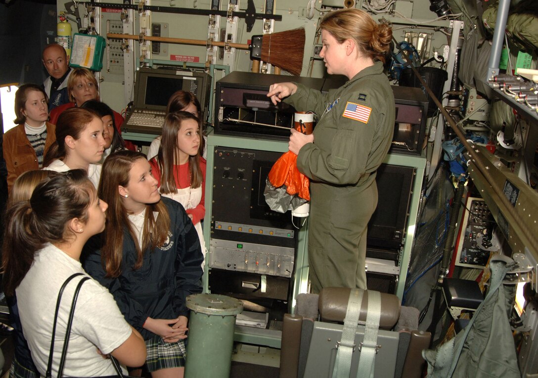 KEESLER AIR FORCE BASE, Miss. -- Students from local schools listen attentively to Capt. Kaitlyn Torbett, Aerial Reconnaissance Weather Officer for the 53rd Weather Reconnaissance Squadron, describing how the Hurricane Hunters collect data in storms. The Biloxi Chamber of Commerce Junior Leadership Tour visited the Air Force Force Reserve WC-130J aircraft, toured active duty dorms, air traffic control simulator and watched a drill team performance. The annual tour gives local students who excel in school an opportunity to better understand the mission and impact of the Air Force. (Air Force Photo by Maj. Chad Gibson)