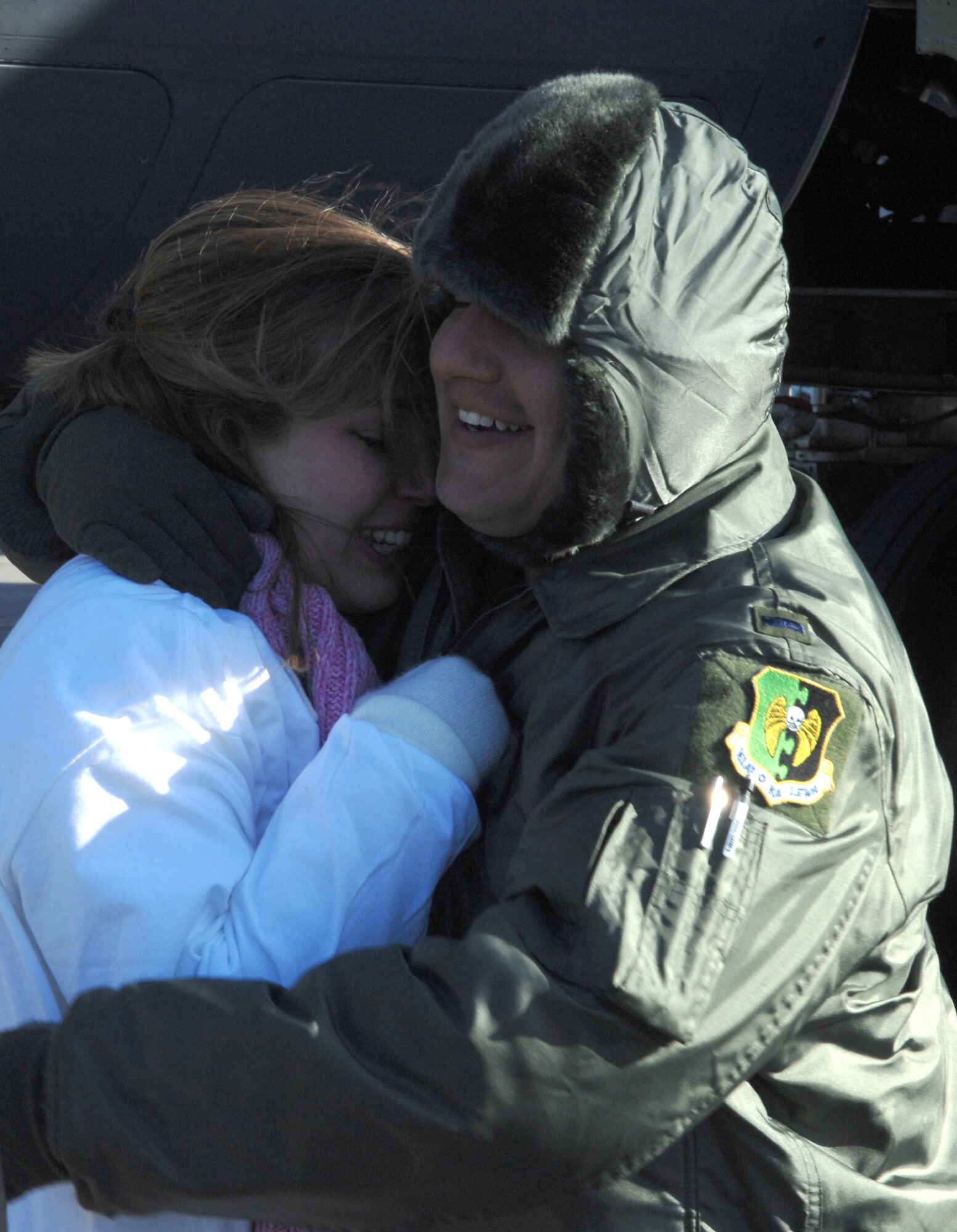 1st Lt. Patrick Godinez hugs his wife, Melissa, after returning Jan. 29 to Minot Air Force Base, N.D., from a deployment to Andersen AFB, Guam. Lieutenant Godinez and other Minot AFB Airmen were met by friends and family upon arriving home from a five-month deployment to Andersen AFB. He is assigned to the 23rd Bomb Squadron. (U.S. Air Force photo/Airman 1st Class Christopher Boitz) 
