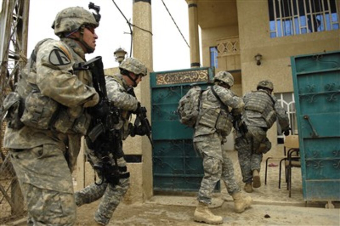 U.S. Army soldiers from Charlie Company, 1st Cavalry Division, 12th Infantry Regiment and Iraqi army soldiers from 3rd Battalion, 2nd Brigade, 5th Iraqi Army Division rush into a house as they conduct a cordon and search in Kahn Bani Sahd, Iraq, on Feb. 6, 2007.  