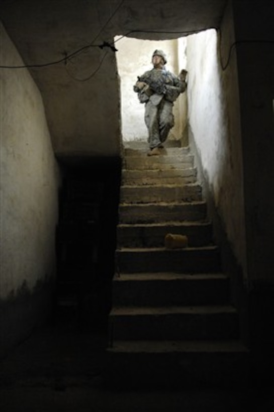 U.S. Army Spc. Nicholas Tompkins, from Charlie Company, 1st Cavalry Division, 12th Infantry Regiment, conducts a cordon and search in Kahn Bani Sahd, Iraq, on Feb. 6, 2007.  