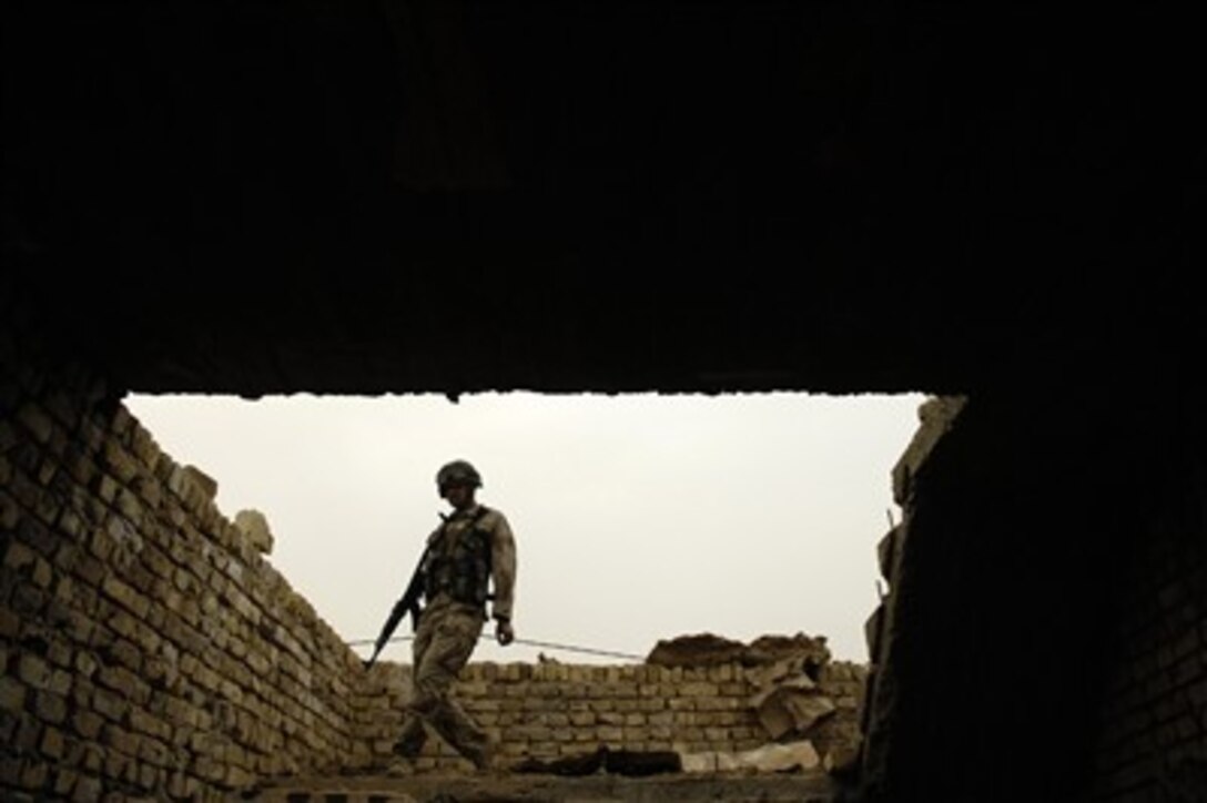 An Iraqi army soldier from 3rd Batallion, 2nd Brigade, 5th Iraqi Army Division conducts a patrol in Kahn Bani Sahd, Iraq, Feb. 6, 2007.