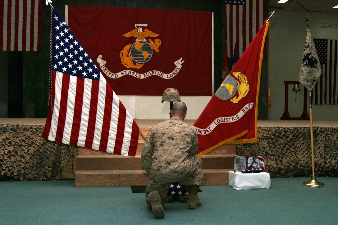 A Marine pays his final respects to Sgt. Alejandro Carrillo, 22, a squad leader with Combat Logistics Team-5, II Marine Logistics Group (Fwd), during a ceremony at Camp Fallujah's Chapel of Hope. Carrillo, a Torrance, Calif., native, was killed while conducting combat operations in Al Anbar Province, Iraq, in support of Regimental Combat Team-6. "He was a great friend and a more-than-capable peer," said fellow squad leader Sgt. Norman Lorente.
