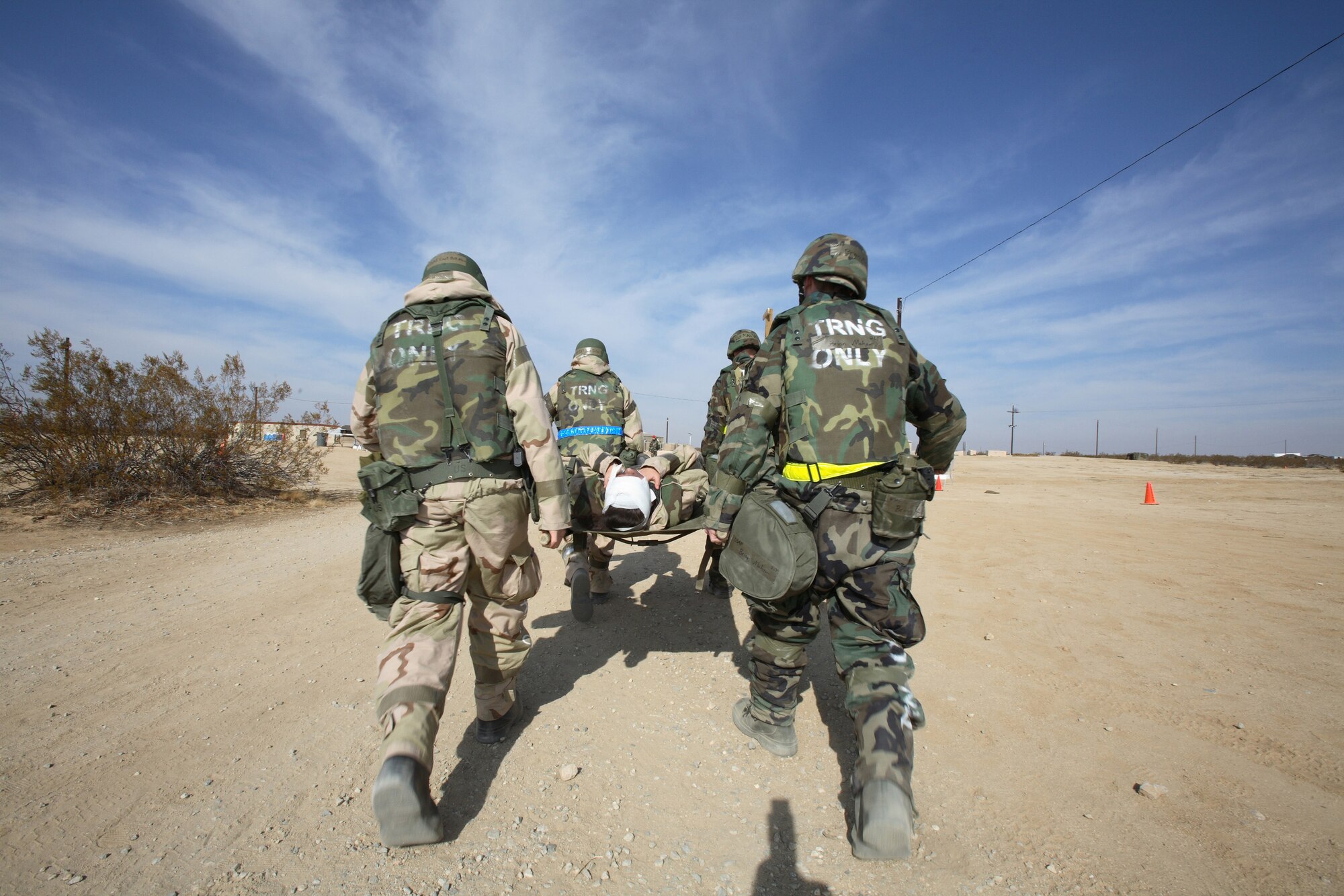 Edwards Airmen carry a litter during Phase II of the Operational Readiness Exercise in Camp Corum here Feb. 2, 2007. (Photo by Jet Fabara)