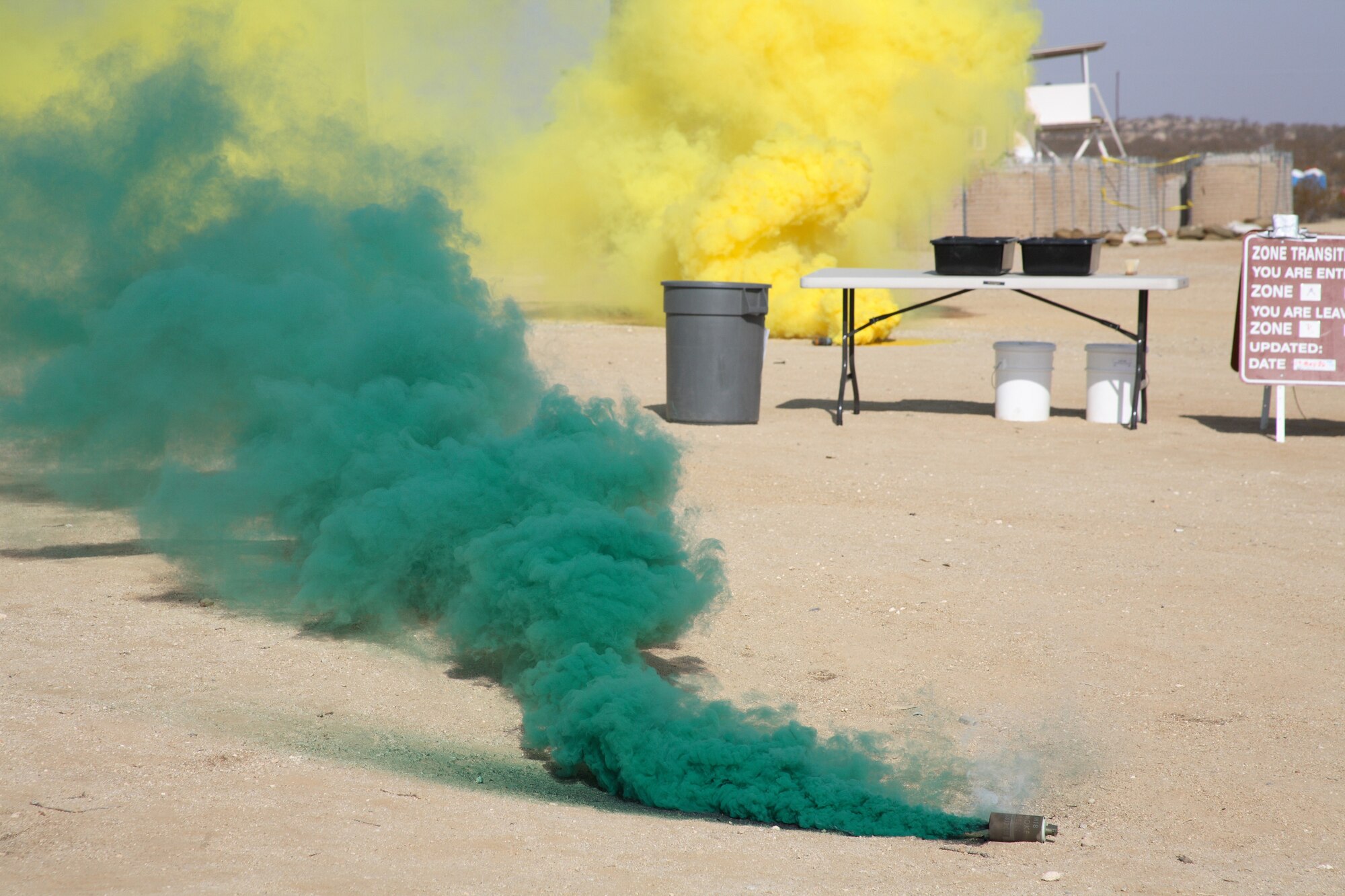 Green and yellow smoke covers Camp Corum after a simulated chemical attack. (Photo by Jet Fabara)