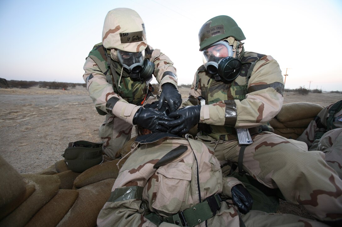 Airmen put a gas mask on a "casualty" during Phase II of the ORE. (Photo by Jet Fabara)
