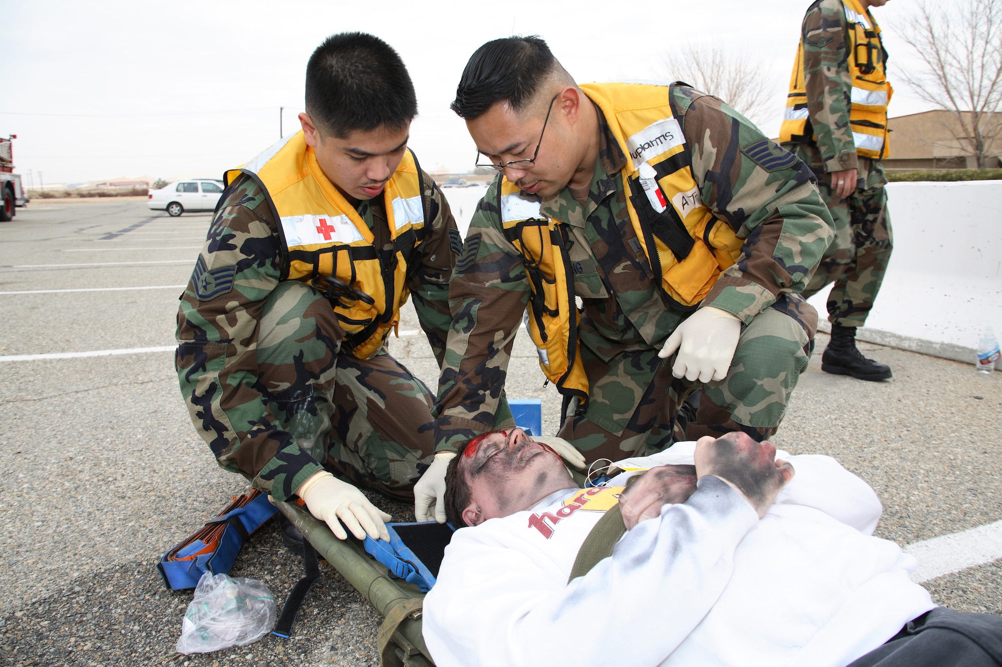 Edwards emergency medical technicians perform medical aid to a "victim" during the emergency management exercise portion of the ORE's Phase I Jan. 30, 2007. (Photo by Jet Fabara)