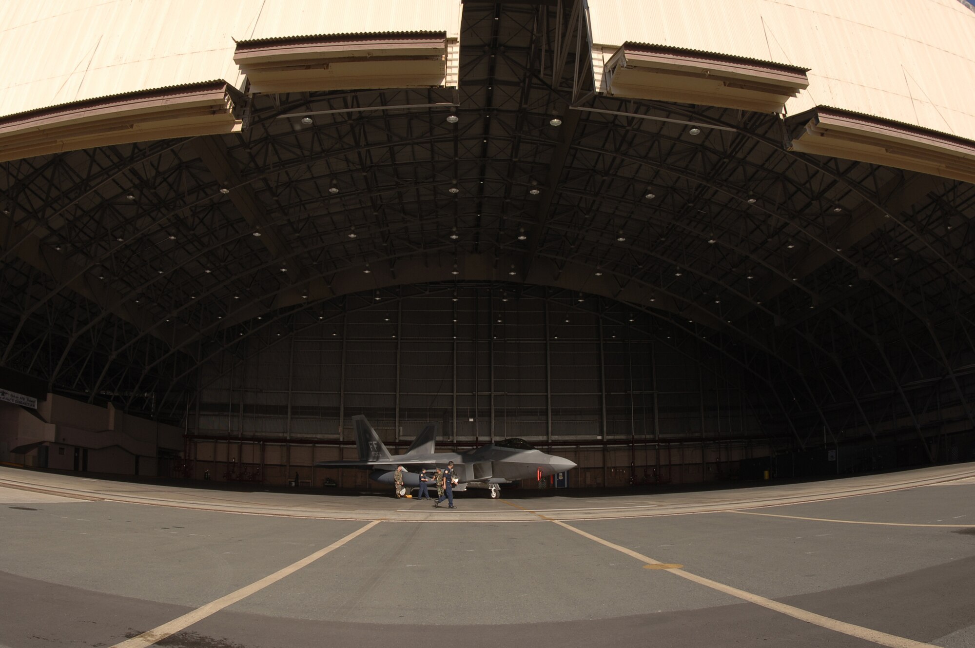 HICKAM AIR FORCE BASE, Hawaii -- An F-22 sits in a hangar here Feb. 8, 2007, while on its way to Kadena Air Base, Japan. The 27th Fighter Squadron, Langley Air Force Base, Va. are deploying 12 F-22s and more than 250 personnel overseas for the first time to Japan. (U.S. Air Force photo by Vanessa Perez) 