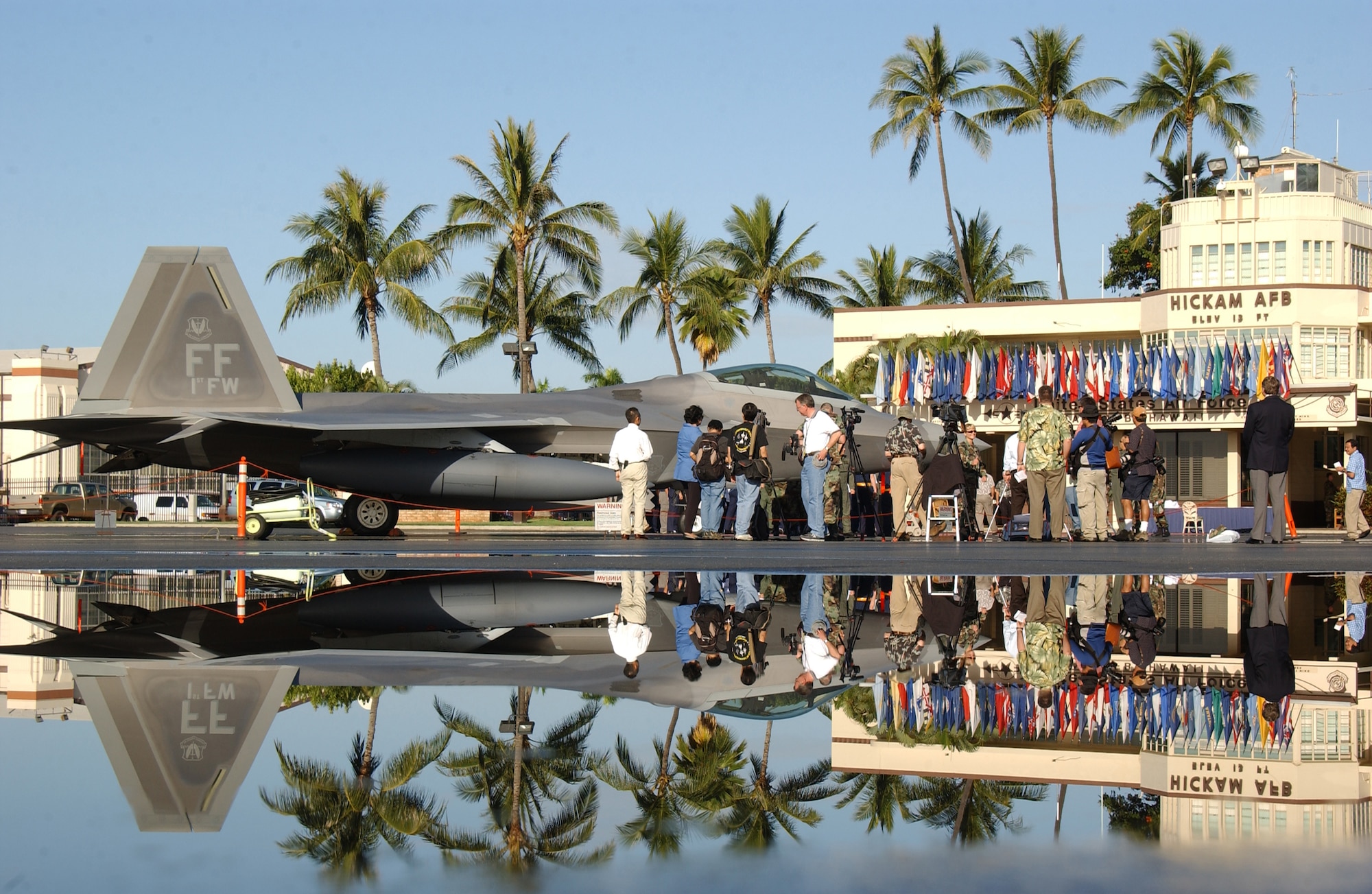 HICKAM AIR FORCE BASE, Hawaii -- Local civic leaders get a closer look at an F-22 here Feb. 8, 2007, while on its way to Kadena Air Base, Japan. The 27th Fighter Squadron, Langley Air Force Base, Va. are deploying 12 F-22s and more than 250 personnel overseas for the first time to Japan. (U.S. Air Force photo by Vanessa Perez) 
