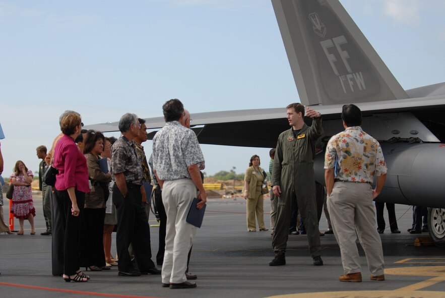 HICKAM AIR FORCE BASE, Hawaii -- Local civic leaders get a close look at one of the F-22s that arrived here Feb. 7, 2007, on their way to Kadena Air Base, Japan. The 27th Fighter Squadron, Langley Air Force Base, Va. are deploying 12 F-22s and more than 250 personnel overseas for the first time to Japan. (U.S. Air Force photo by Vanessa Perez) 