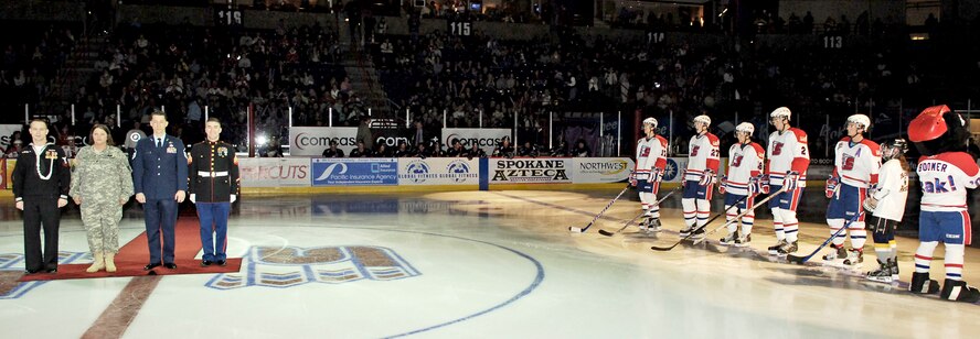FAIRCHILD AIR FORCE BASE, Wash. -- Navy Boatswains Mate 2nd Class Jesse Morris, Navy Recruiter; Army Spc. Cassie Setter, 659th Engineering Construction Support Unit; Master Sgt. Mark Thrower, 92nd Civil Engineer Squadron; Marine Sgt. Brett Collins, Battery P 5th Battalion 14th Marines; and members of the Spokane Chiefs hockey team stand on the ice during an opening ceremony before the game Saturday. The Chiefs hosted a military appreciation night for local servicemembers and their families. (U.S. Air Force photo/Senior Airman Anthony Ennamorato)