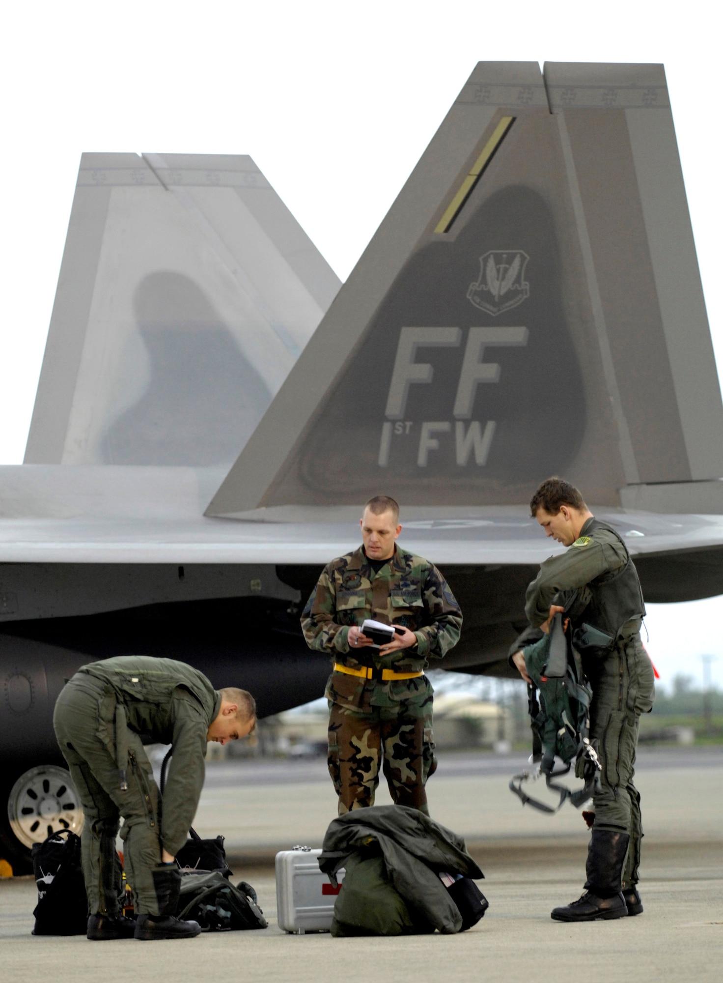 A crew chief talks to F-22 Raptor pilots after they landing Feb. 7 at Hickam Air Force Base, Hawaii. The F-22s and more than 250 Airmen from the 27th Fighter Squadron at Langley Air Force Base, Va., are bound for Kadena Air Base, Japan, for the aircraft's first overseas operational deployment. (U.S. Air Force photo/Tech. Sgt. Shane A. Cuomo) 