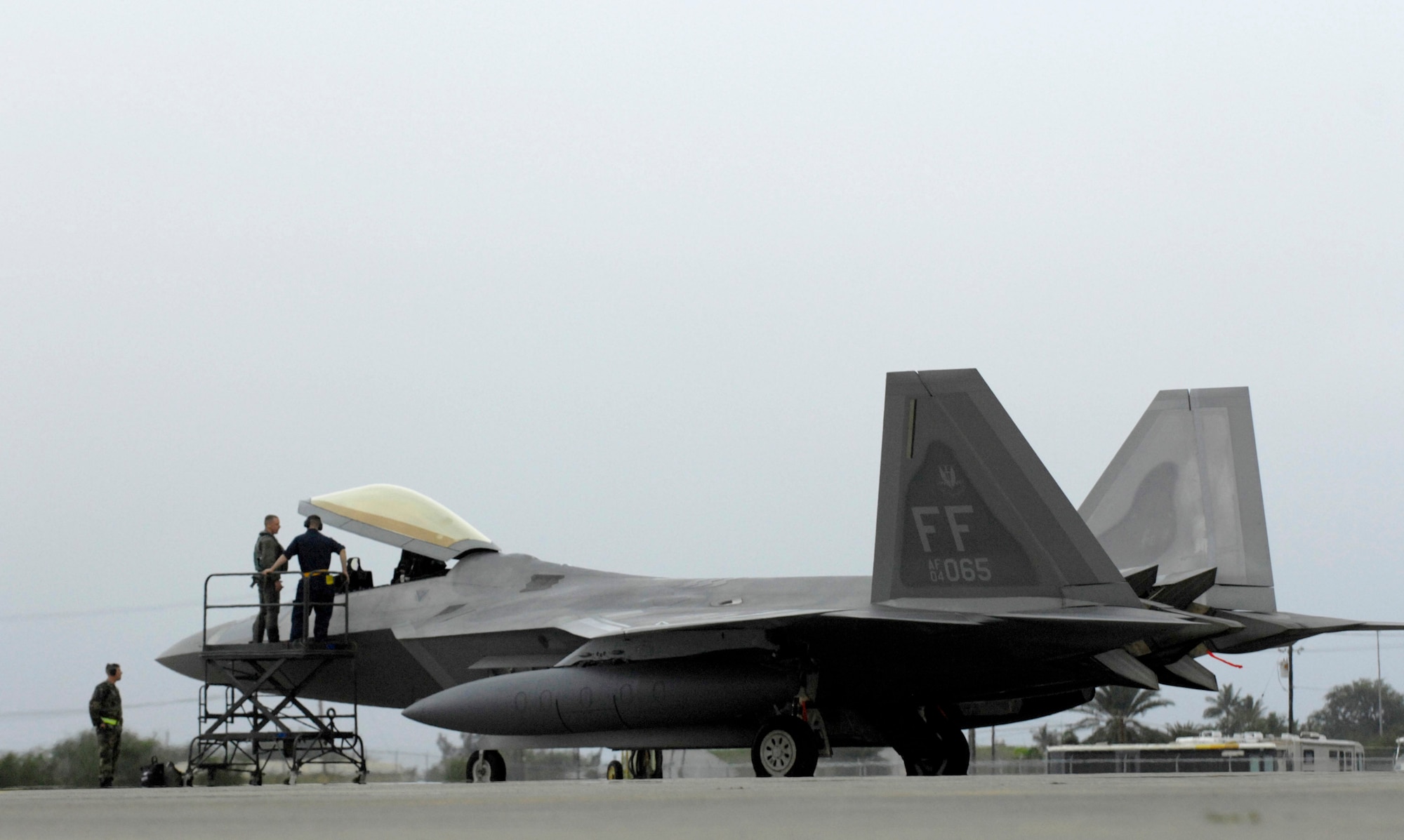 A crew chief talks to the pilot of an F-22 Raptor after parking Feb. 7 at Hickam Air Force Base, Hawaii. The F-22s and more than 250 Airmen from the 27th Fighter Squadron at Langley Air Force Base, Va., are bound for Kadena Air Base, Japan, for the aircraft's first overseas operational deployment. (U.S. Air Force photo/Tech. Sgt. Shane A. Cuomo) 