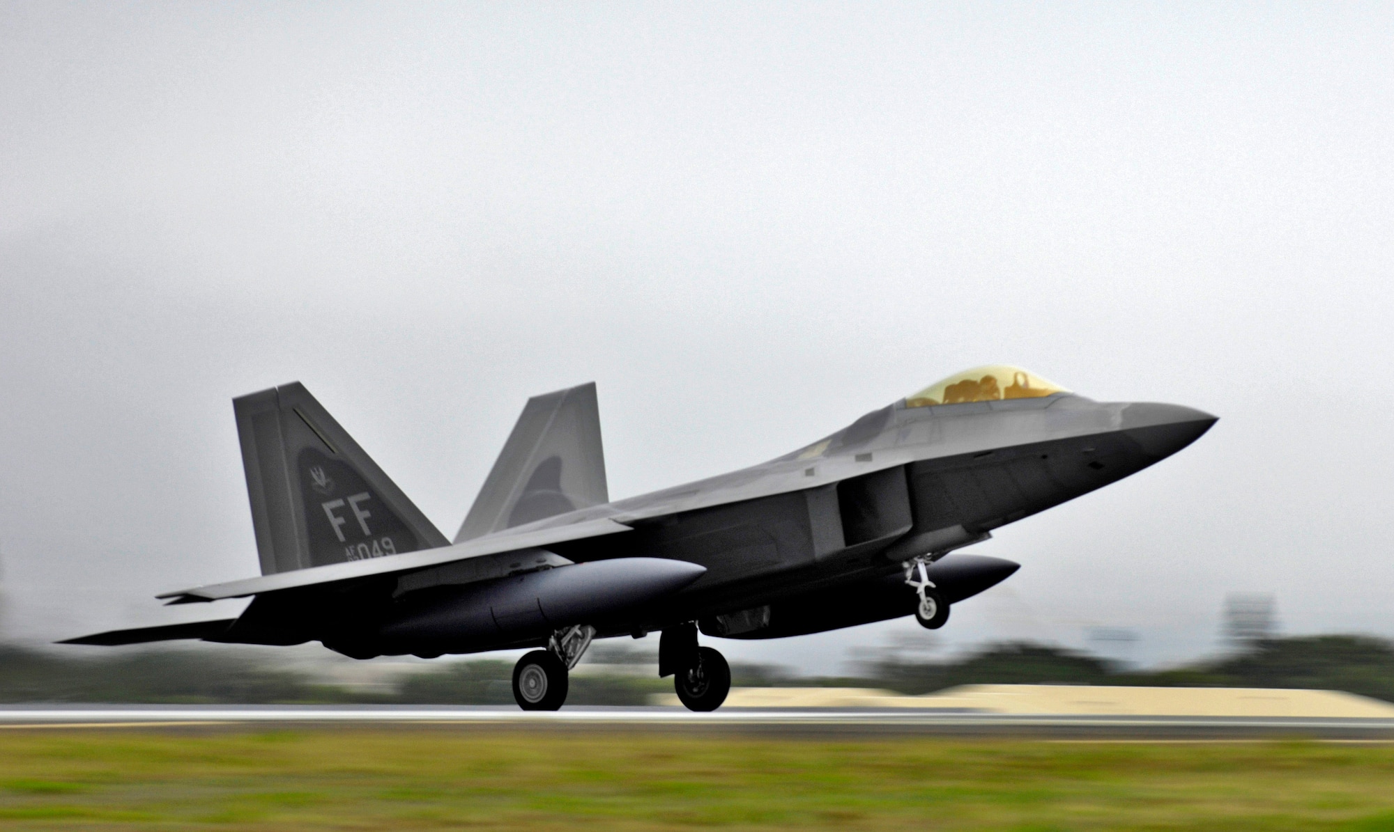 The first of 12 F-22 Raptors lands for a brief layover Feb. 7 at Hickam Air Force Base, Hawaii. The F-22s and more than 250 Airmen from the 27th Fighter Squadron at Langley Air Force Base, Va., are bound for Kadena Air Base, Japan, for the aircaft's first overseas operational deployment. (U.S. Air Force photo/Tech. Sgt. Shane A. Cuomo) 