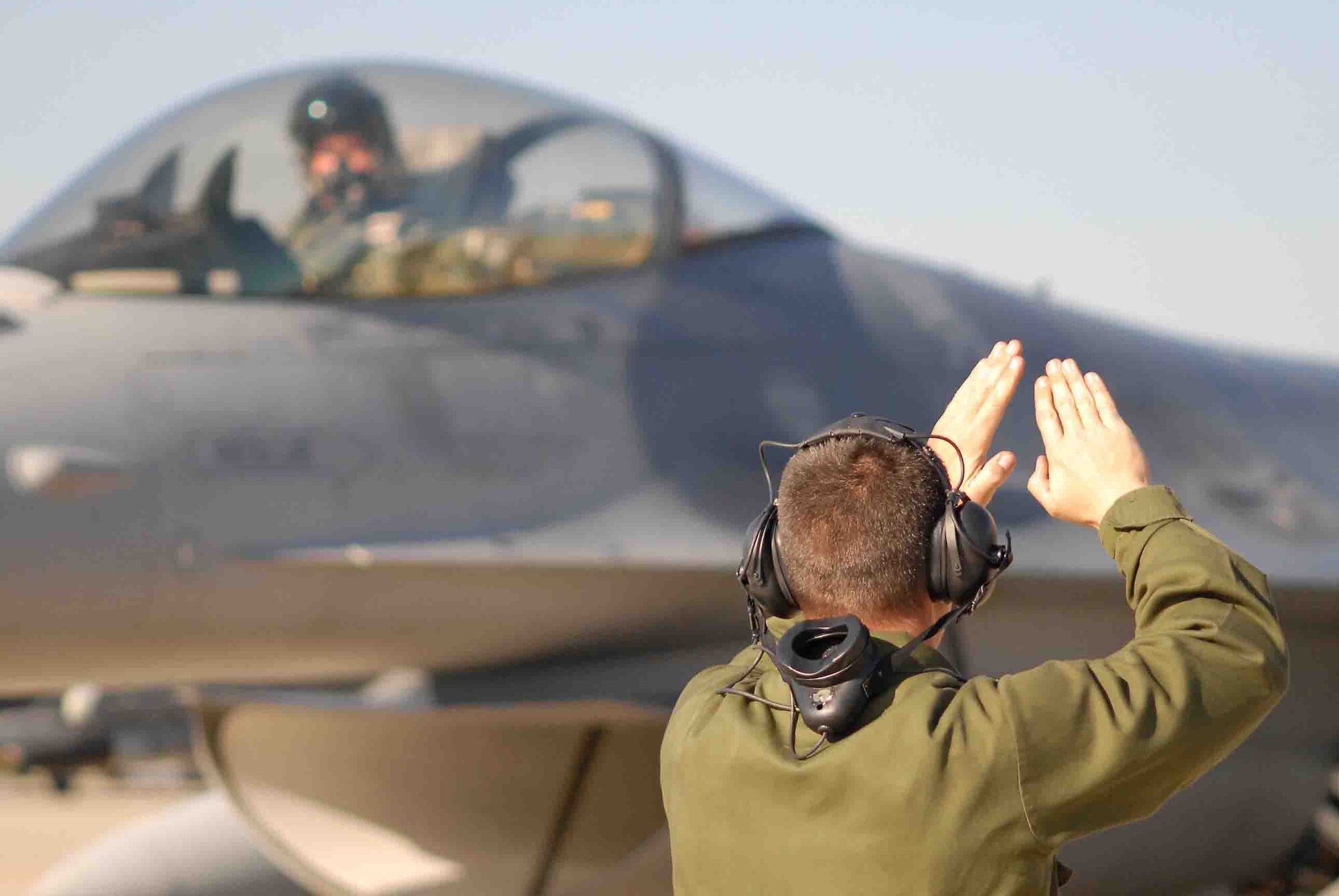 SHAW AIR FORCE BASE, S.C. -- Staff Sgt. Donald Slayton, 77th Fighter Squadron crew chief, launches an F-16CJ during the Operation Iron Thunder exercise Feb. 7. The four-day exercise prepares pilots for future contingency operations by exposing them to missions identical to those faced in combat. (U.S. Air Force photo/Tech. Sgt. James Arrowood)