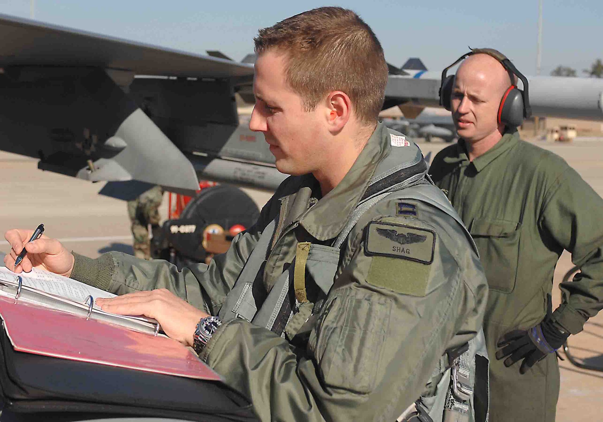 SHAW AIR FORCE BASE, S.C. -- Capt. Todd Adams (left) and Staff Sgt. Donald Dunn , 77th Fighter Squadron, prepare for an Operation Iron Thunder flight Feb. 7. Iron Thunder is a four-day excercise that prepares Airmen for operations while deployed. (U.S. Air Force Photo/Airman 1st Class Matthew Davis)
