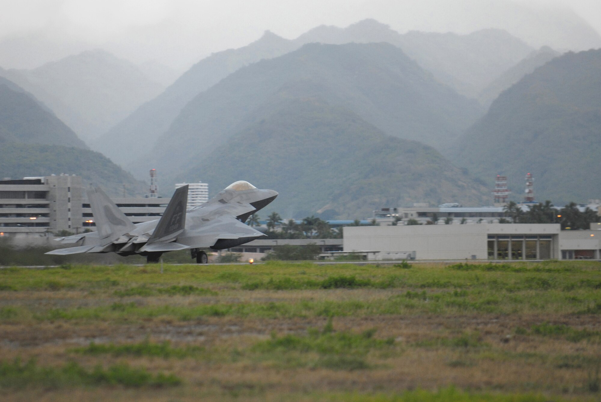 HICKAM AIR FORCE BASE, Hawaii -- The first F-22 lands here Feb. 7, 2007, on its way to Kadena Air Base, Japan. The 27th Fighter Squadron, Langley Air Force Base, Va. are deploying 12 F-22s and more than 250 personnel overseas for the first time to Japan. (U.S. Air Force photo by Vanessa Perez) 

