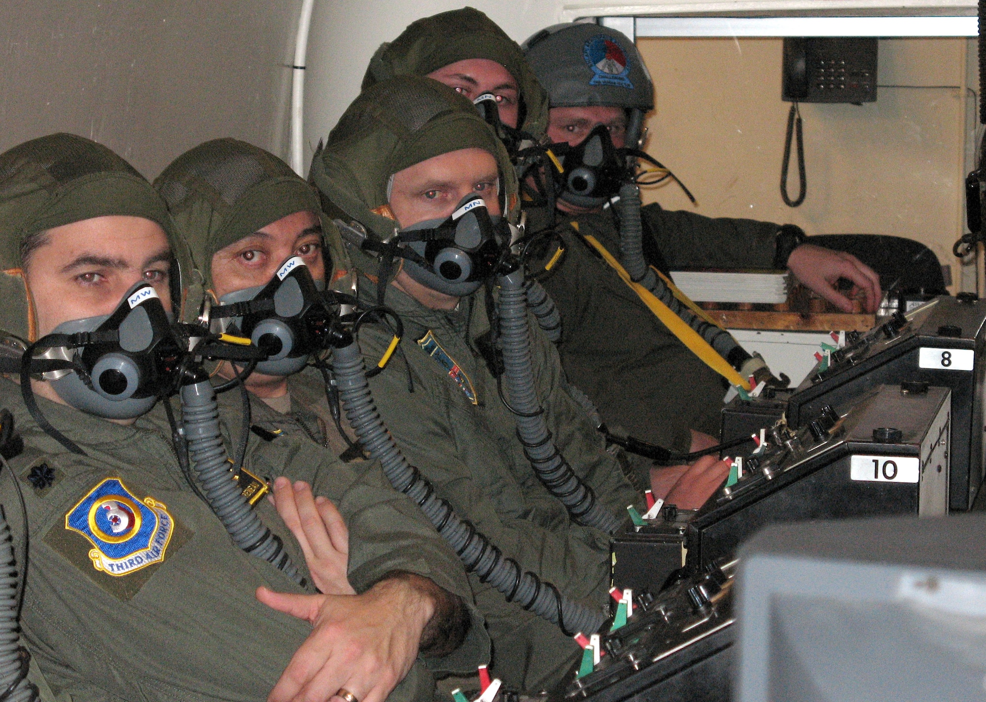 Students look on during a pre-flight brief in the high-altitude training chamber Feb. 7 at the Center for Man and Aviation in the Netherlands. The chamber simulates altitudes up to 30,000 feet and allows students to see firsthand the effects of hypoxia. (U.S. Air Force photo/Staff Sgt. Leigh Bellinger) 