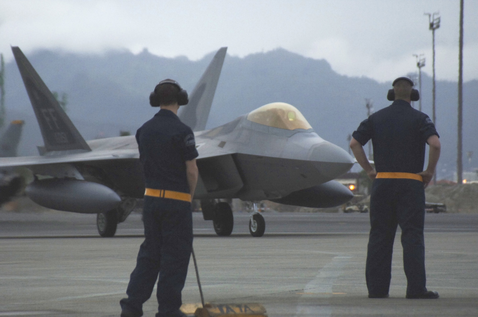 HICKAM AIR FORCE BASE, Hawaii -- The first F-22 lands here Feb. 7, 2007, on its way to Kadena Air Base, Japan. The 27th Fighter Squadron, Langley Air Force Base, Va. are deploying 12 F-22s and more than 250 personnel overseas for the first time to Japan. (U.S. Air Force photo by Vanessa Perez) 


