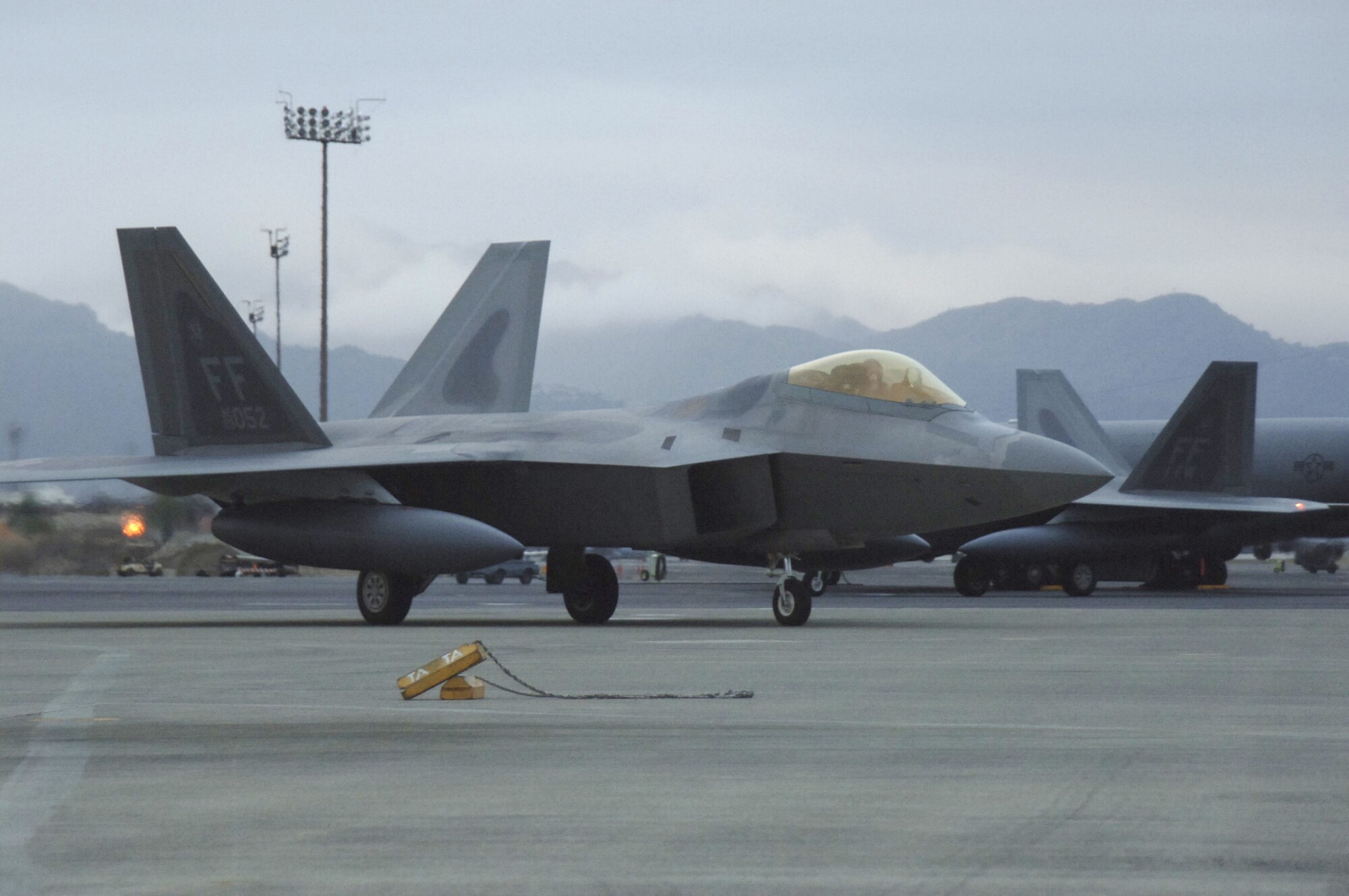 HICKAM AIR FORCE BASE, Hawaii -- The first F-22 lands here Feb. 7, 2007, on its way to Kadena Air Base, Japan. The 27th Fighter Squadron, Langley Air Force Base, Va. are deploying 12 F-22s and more than 250 personnel overseas for the first time to Japan. (U.S. Air Force photo by Vanessa Perez) 

